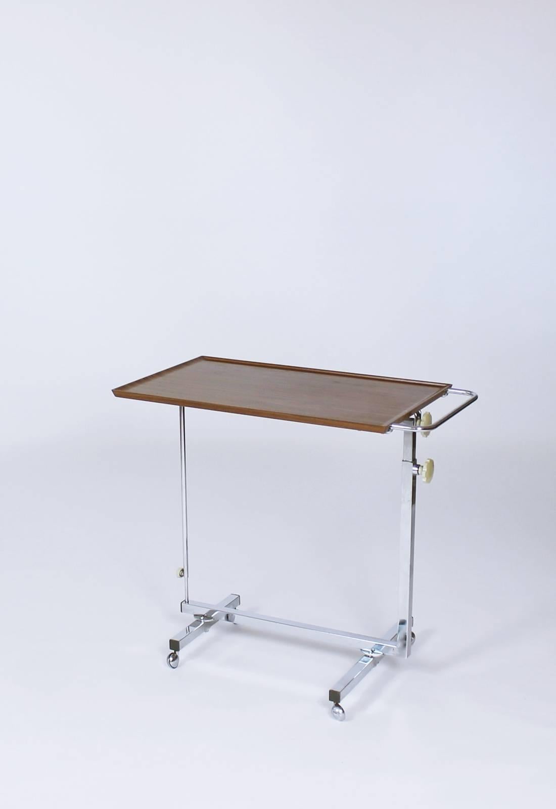 Stylish occasional table Variett by Bremshey made in Germany. The frame is made of chrome-plated square tube, the panel is made of Resopal. Chrome-plated castors, adjustment knobs in bright plastic. Height adjustable with tilting plate. Versatile