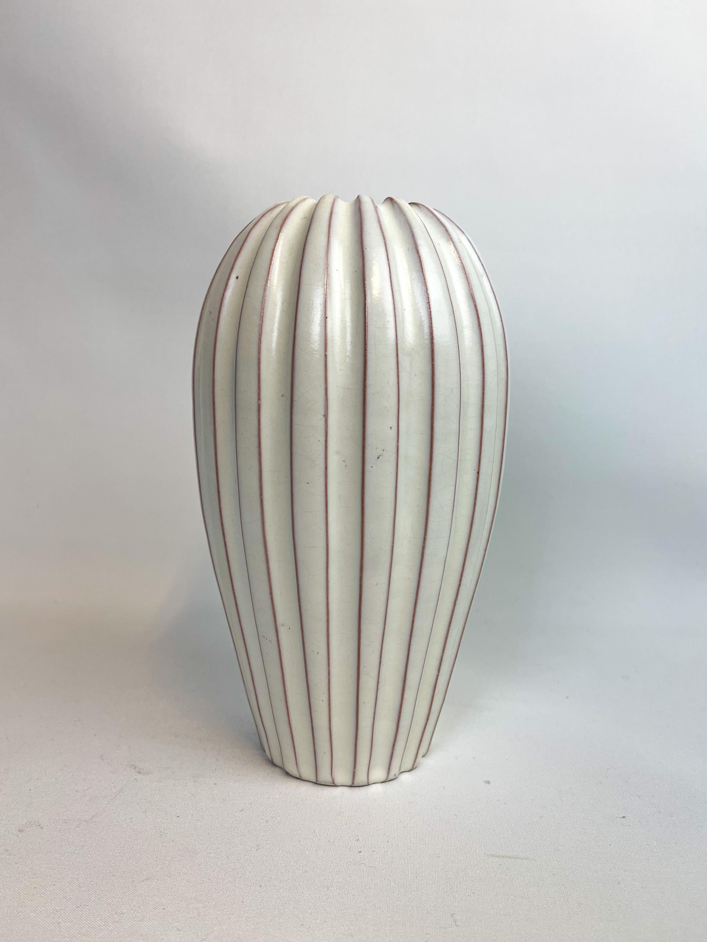 Wonderful vase produced at Ekeby and designed by Vicke Lindstand in the 1940s.
Its streamline shape makes it perfectly adapted to the modern home. Drilled hole on the top. We also have the floor vase to make the perfect match if wanted a pair.