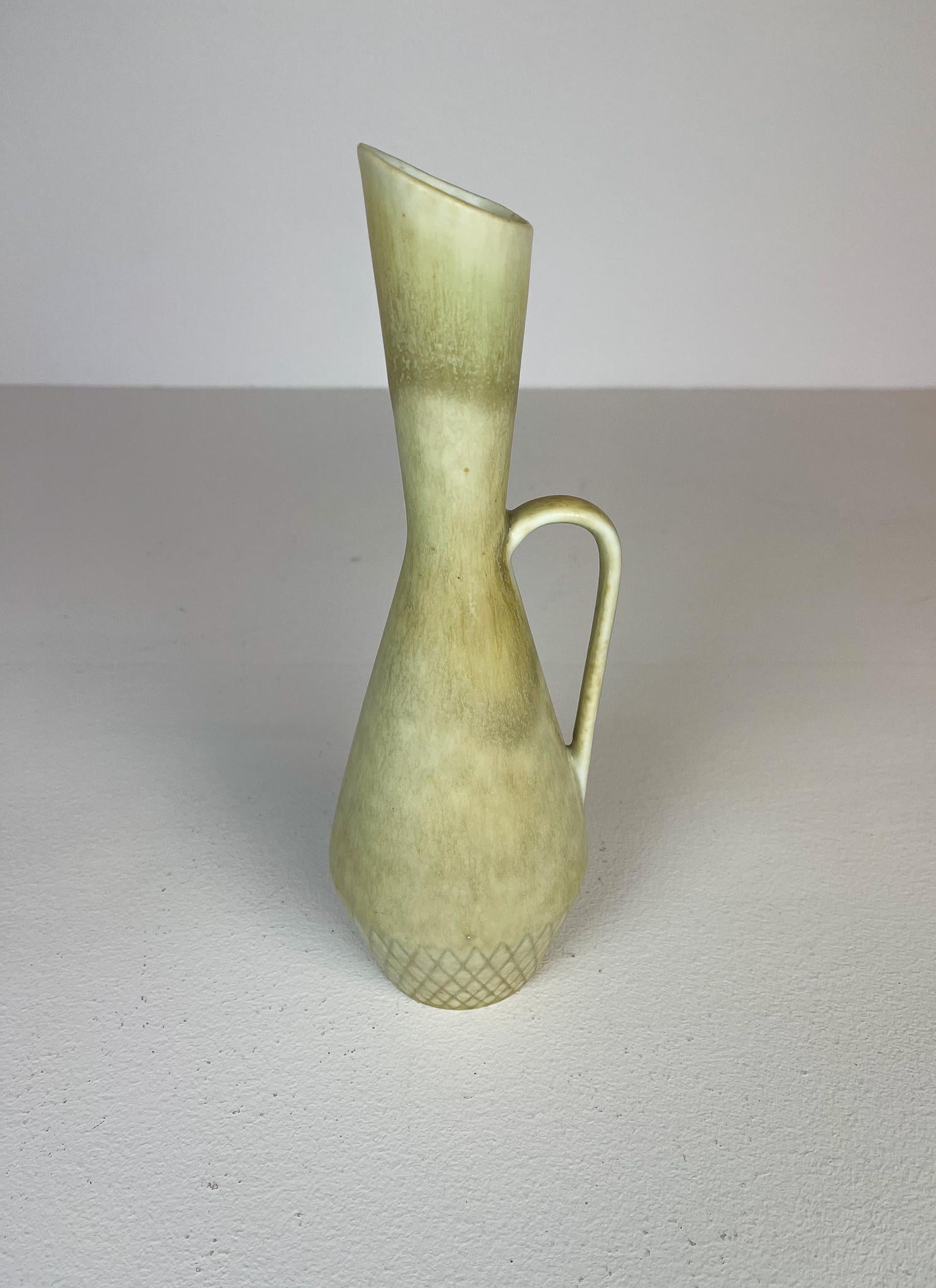 Nicely sculptured vase with glaze that shifts in colors. 
Made in Sweden at Rörstrand factory and designed by C-H Stålhane. 

Very nice condition. 
Vase incised: R three crowns, Sweden, CHS, SYD 

Dimensions: Height: 27 cm (10.4