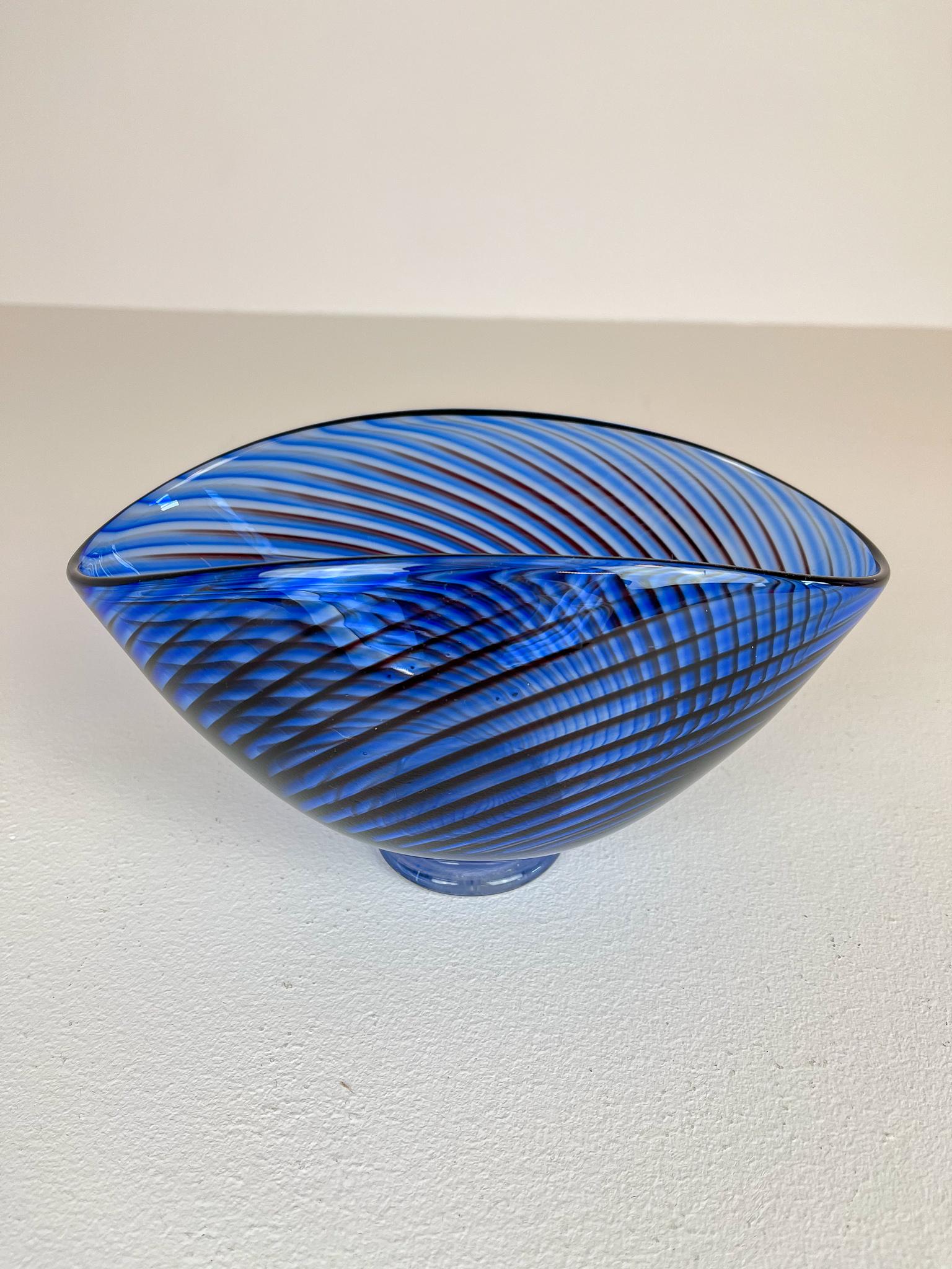 Wonderful blue checkered vase produced in Sweden at the Kosta factory. Designed by Vicke Lindstrand.
This piece is a large version of the series Colora, it stands on a foot and have black lines checkered into the blue colored vase. Its beautifully