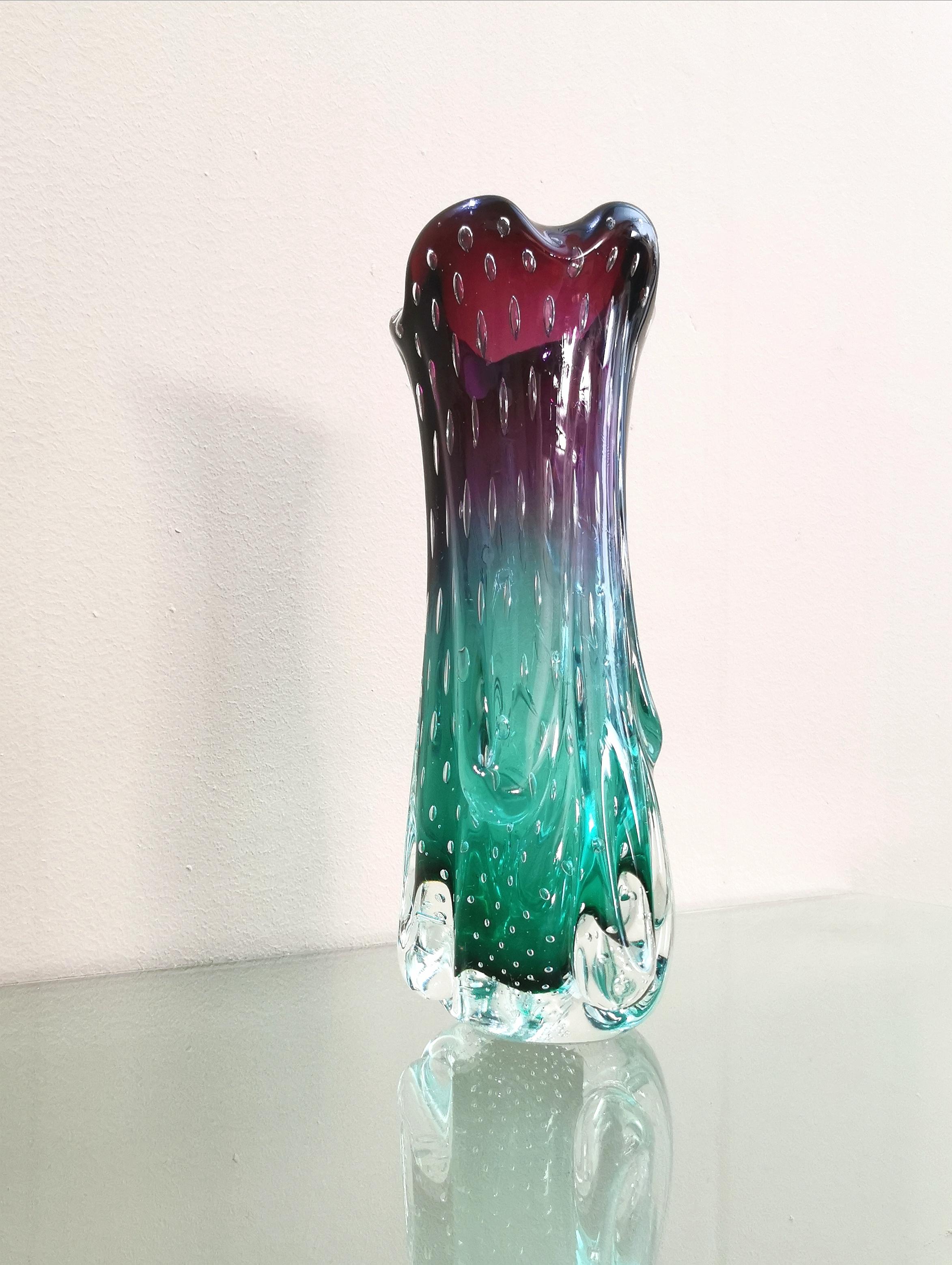 Vase produced by the famous and ancient Italian glassmaker Seguso in the 70s. The vase was made of submerged and bullicant Murano glass, which is a particular decorative effect used in thick glass which consists of a myriad of bubbles, which in this