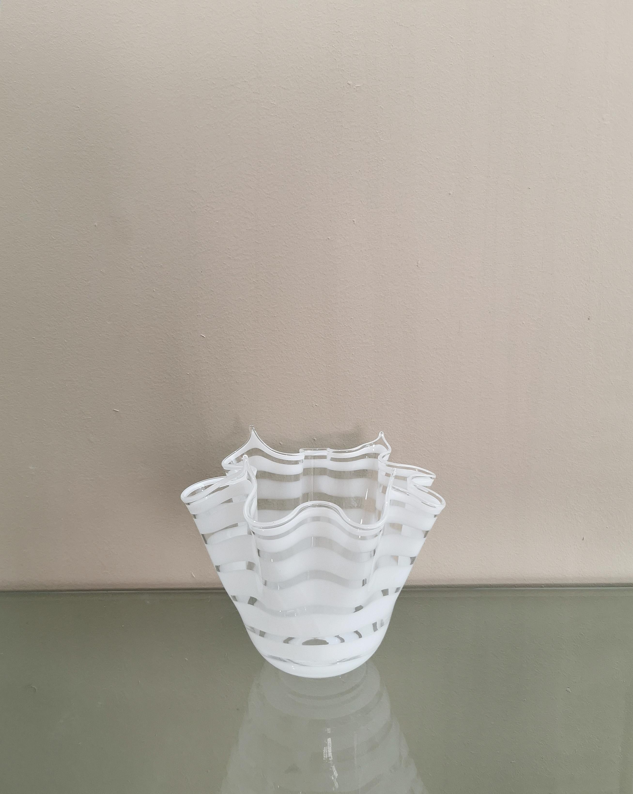 Vase designed in the style of Venini, produced in Italy in the 60's / 70's. The vase was made of white and transparent hand-blown Murano glass, with the particularity of having a wavy shape almost forming a handkerchief.