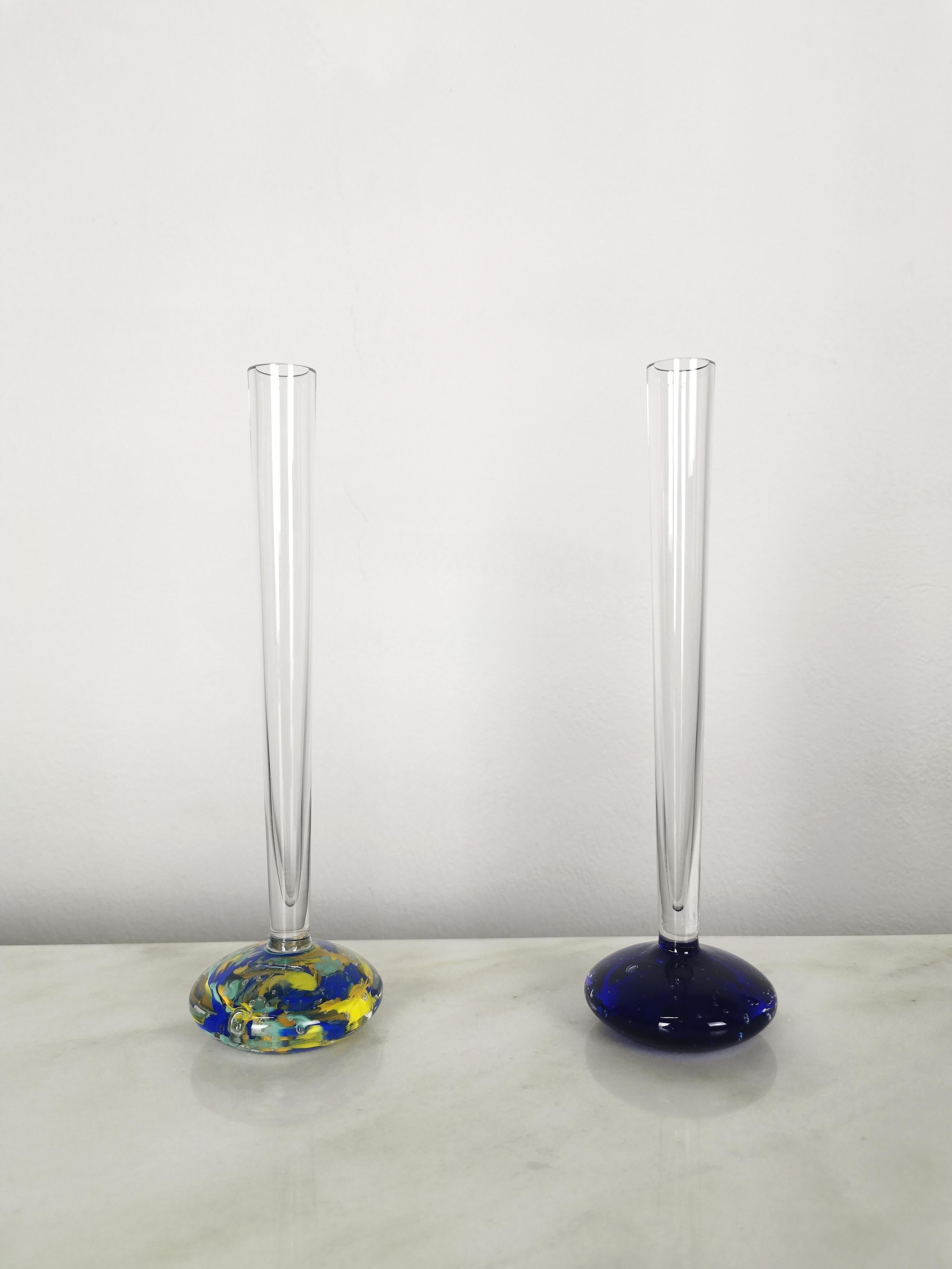 Set of 2 long neck vases produced in Italy in the 70s. Each single vase was made of transparent Murano glass and circular on the lower part with the famous sommerso and bullicante techniques, which together create a particular combination of vibrant