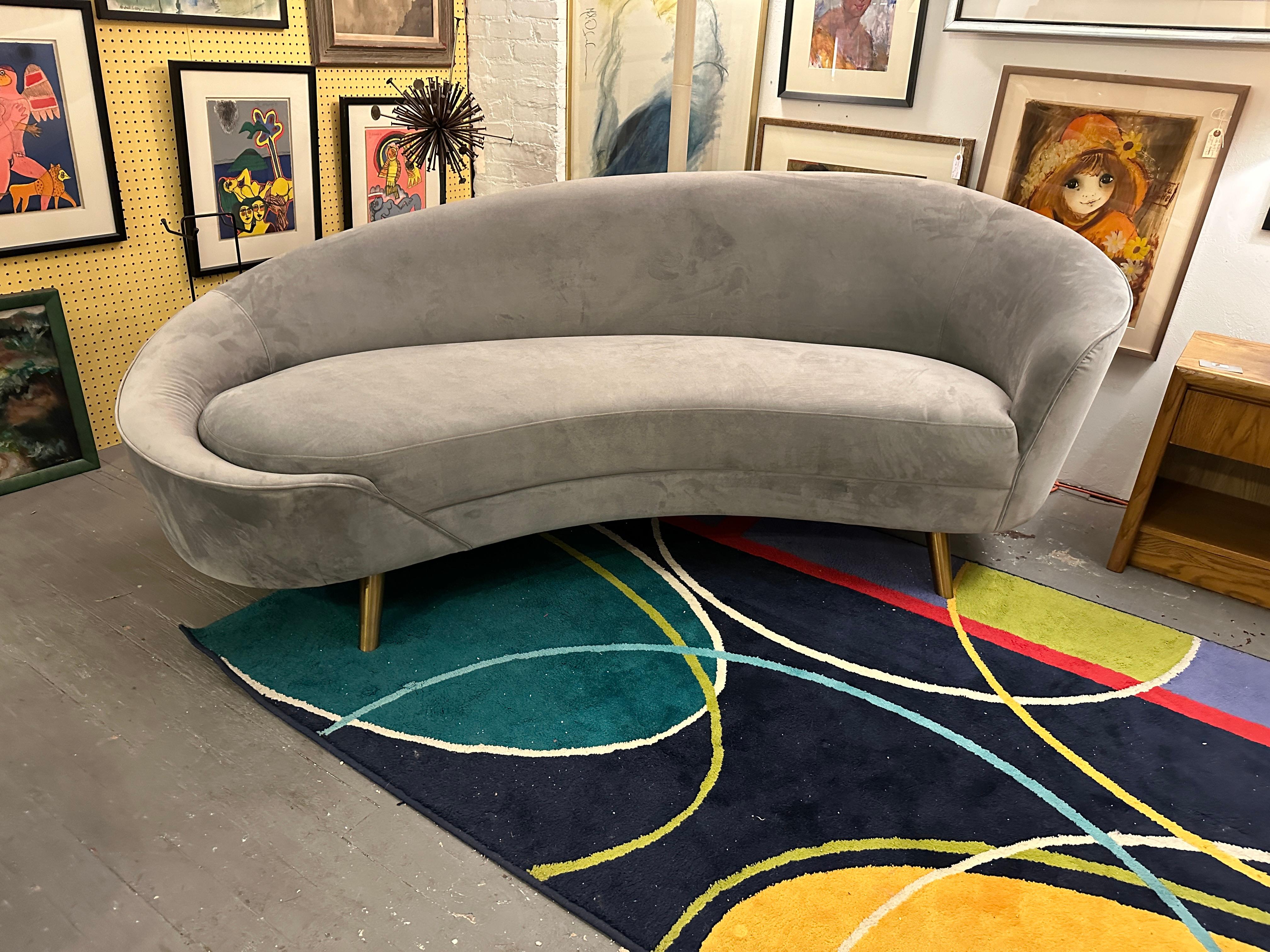 This sofa in Federico Munari style, is upholstered in a grey hue velvet. A true centerpiece, the curved sofa is a sinuous, armless design rife with mid-century elegance and a modern minimalist allure.

Born in Gorizia, Italy, Munari studied at the