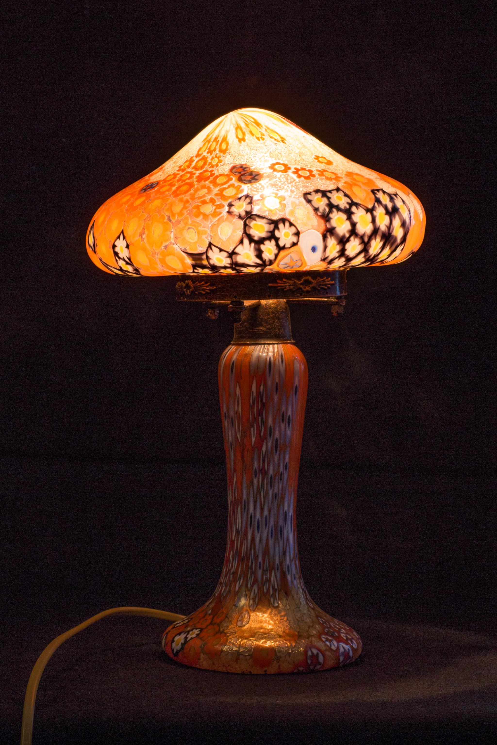 This delightful Italian table lamp was designed by Galliano Ferro and is made of Murano glass. 
The expressive mosaic design on this beautiful table light is called 