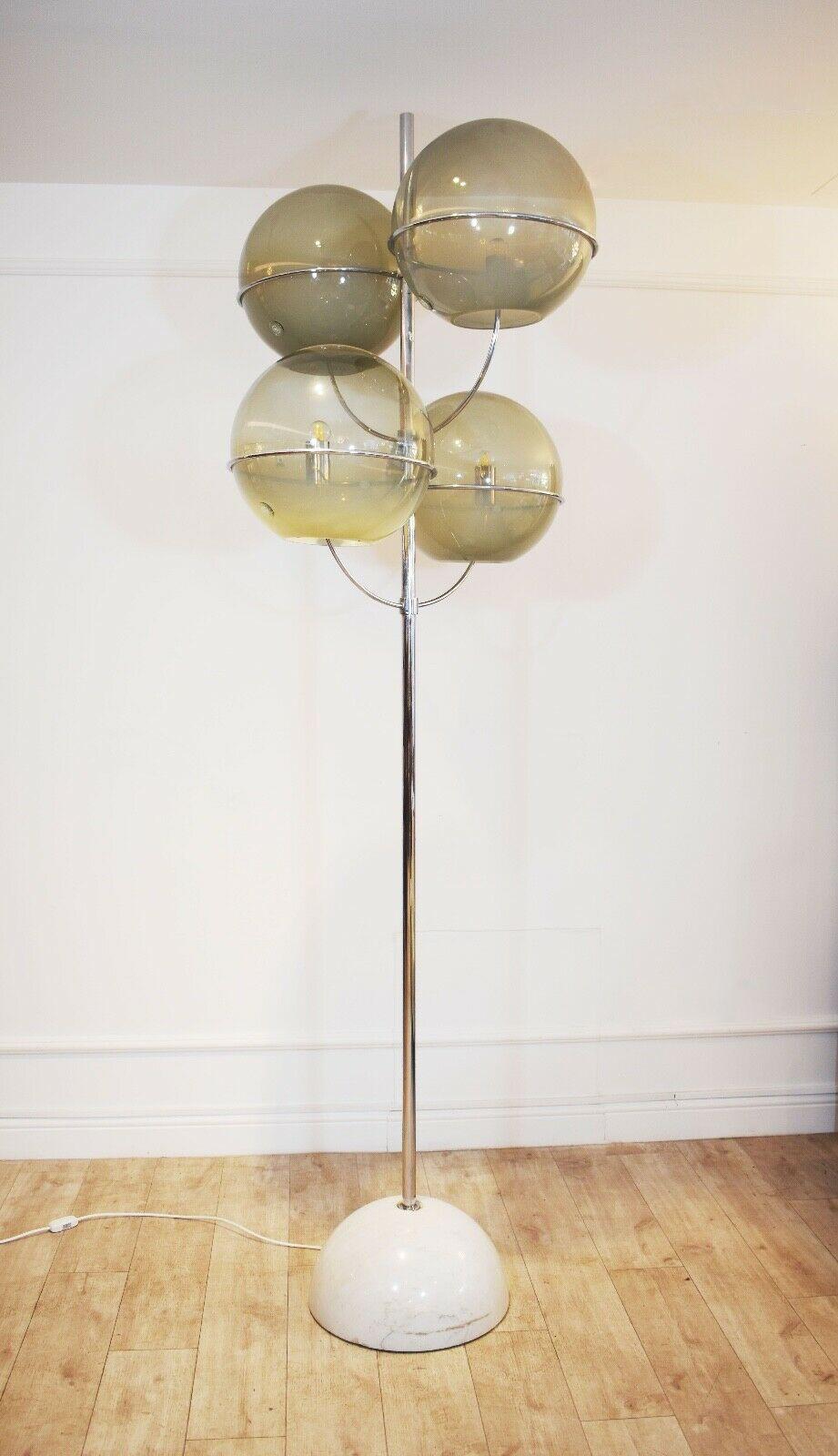 This is an extremely rare original floor lamp by Vico Magistretti for Knoll International, named the 'Colleoni' designed in 1968. 

With a white marble base, tubular steel and chrome-plated frame and glass each shade with applied glass seal