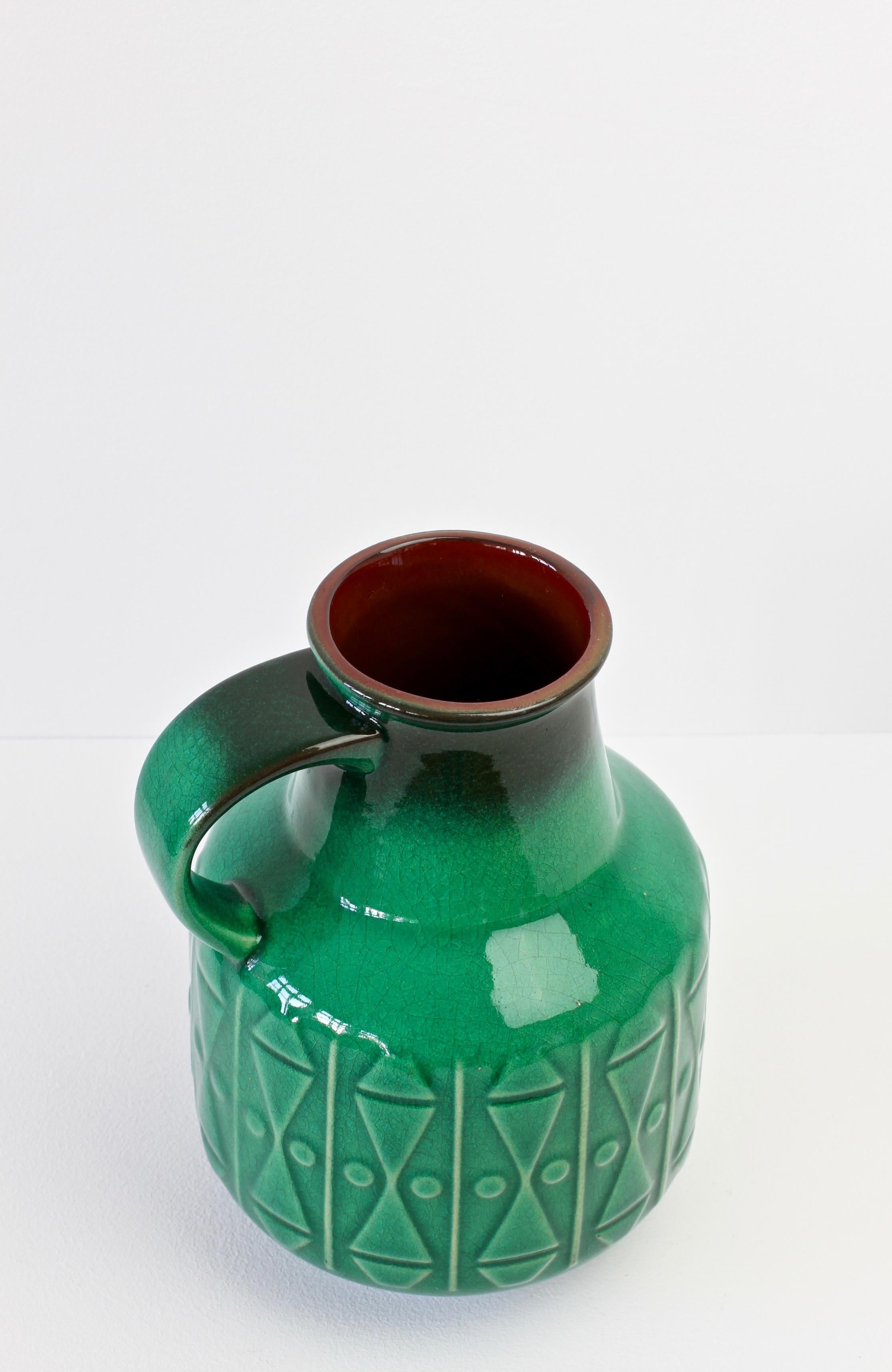 Green vase with modernist design by Graflich Pottery, Germany, circa 1970. The vase with it's delightful form, emerald green crackle glaze and relief pattern, is a wonderful design statement and a fun way to add a bit of fun in to a room with this