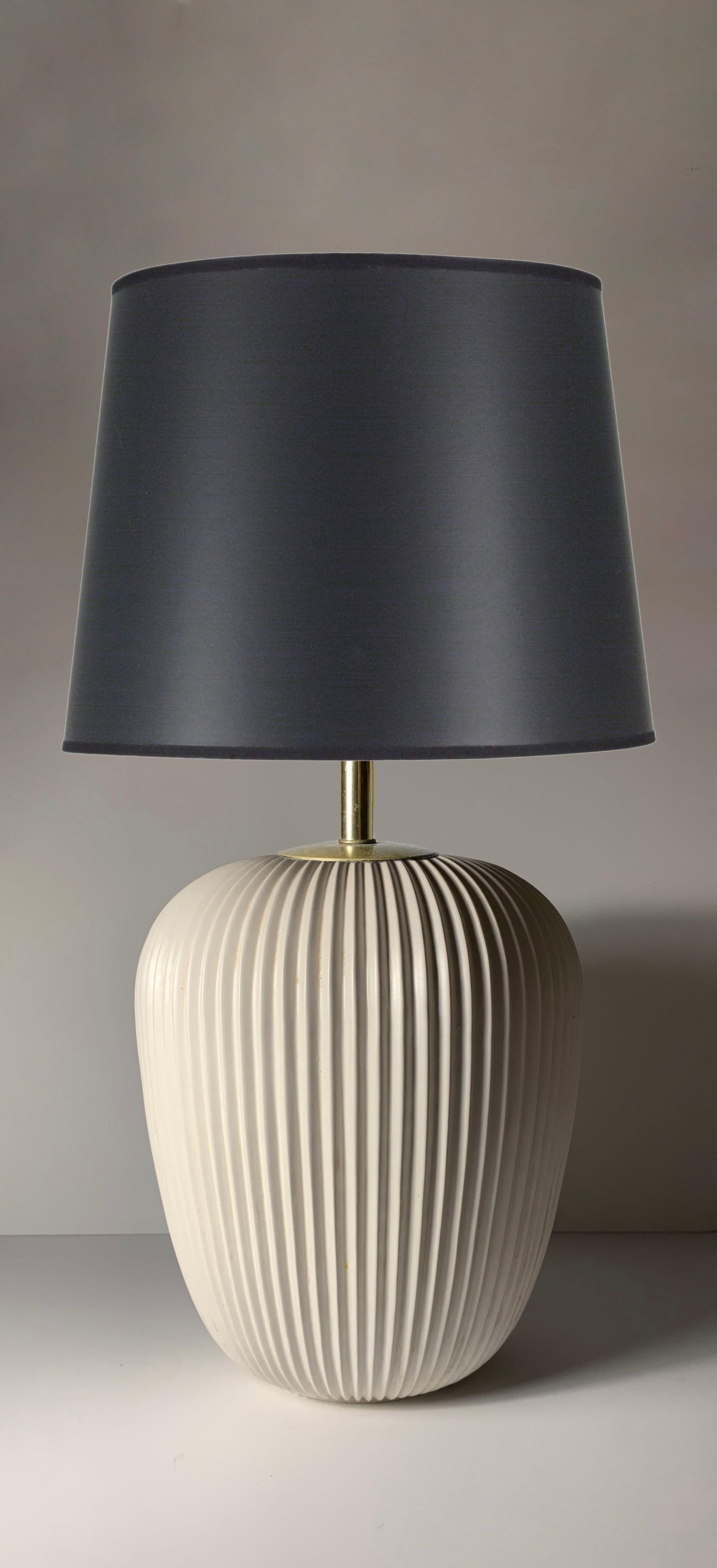 Midcentury vintage ceramic lamp base by Gerald Thurston for Lightolier.

As shown, ceramic base requires specifying hardware and wiring. First photo with black shade is for reference only. We do have a black ceramic version of the lamp that is