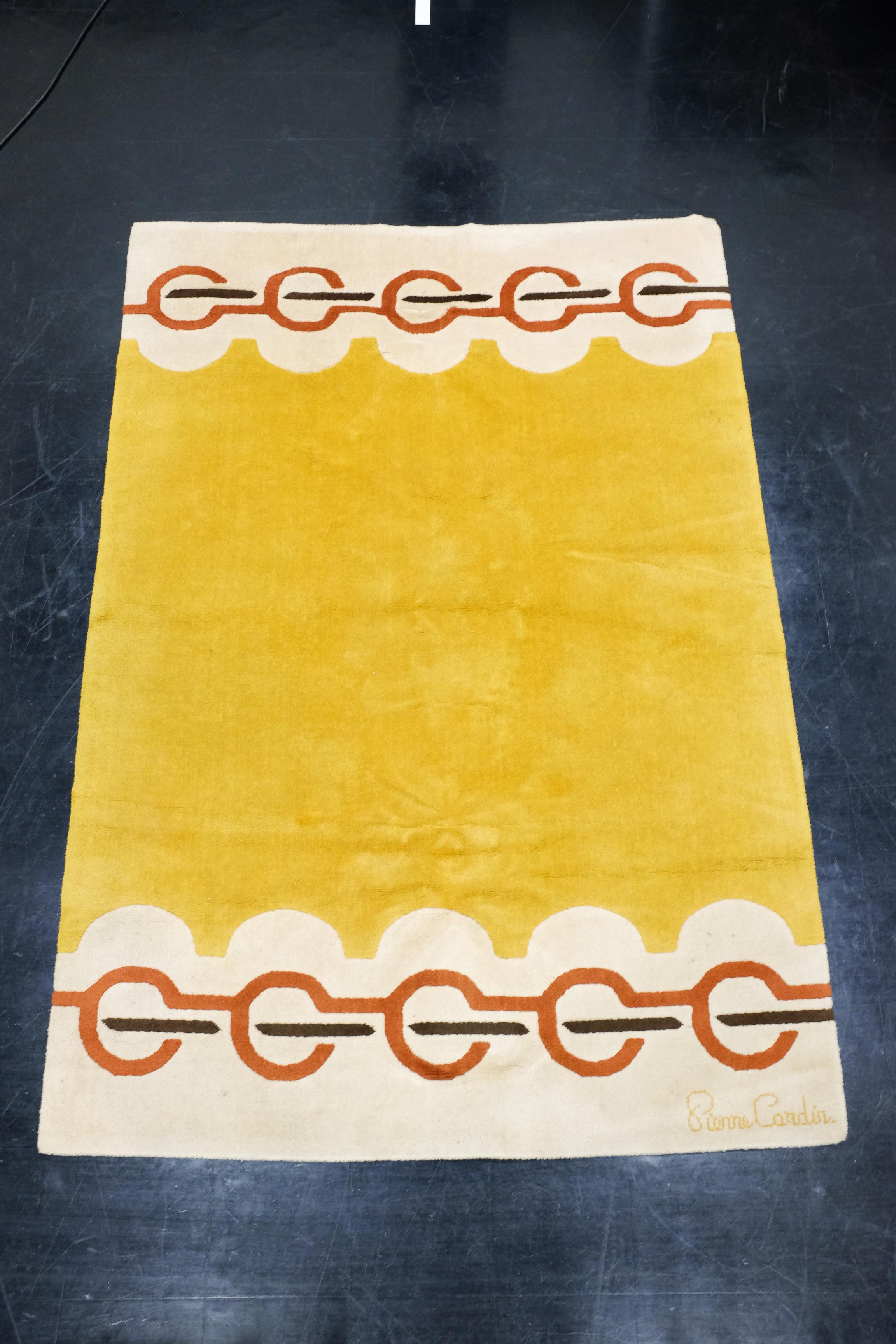 A very decorative carpet designed by French designer Pierre Cardin. The carpet has a space age feel to is with a nice pallet of colors. It is a larger model that measures 270 x 183 cm. Signature in lower right corner. 

Very good vintage condition