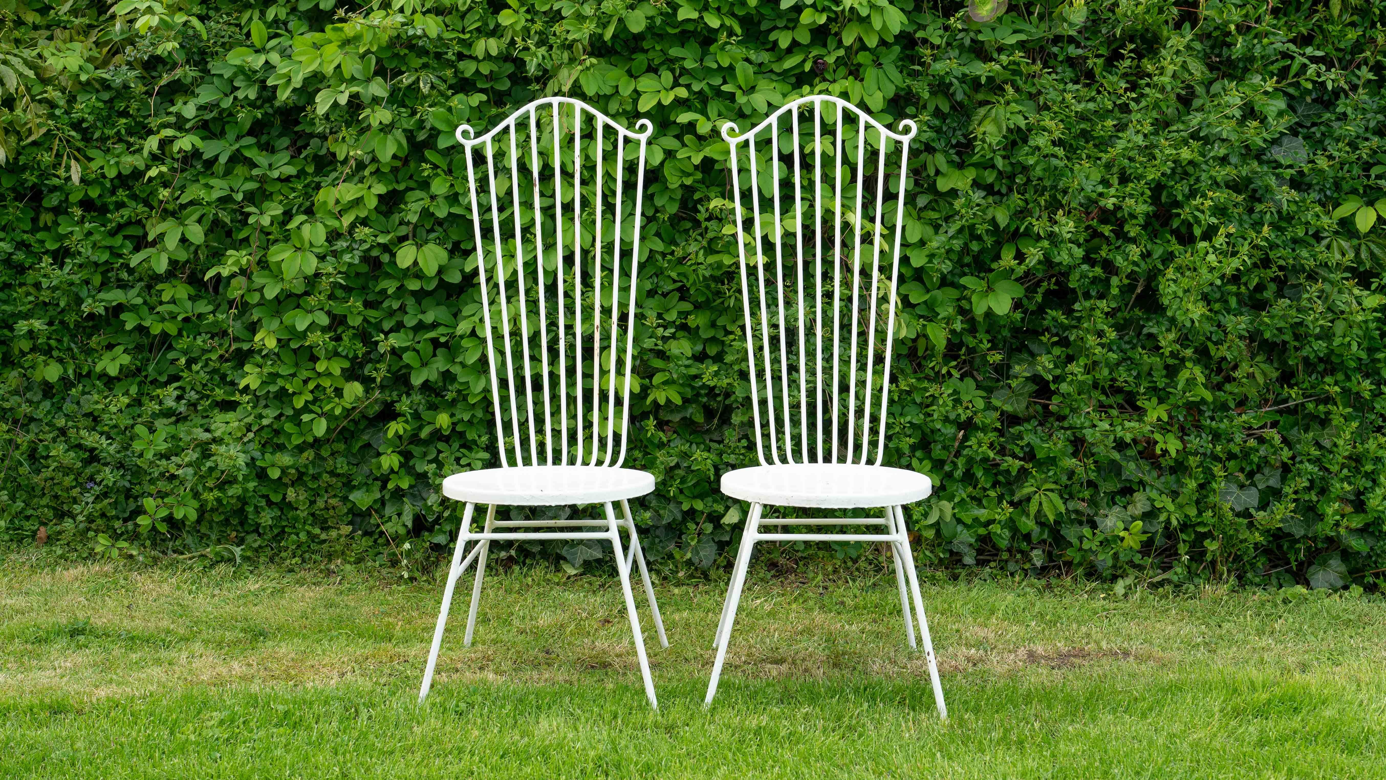 Two vintage midcentury garden chairs from the 1950s. Designer and Manufacturer unknown. Executed in Metal / Iron, in style of Mathieu Mategot. Charming strong patination, rust and wear. Dimensions: width: 38cm, depth: 46cm, height: 102cm, seat