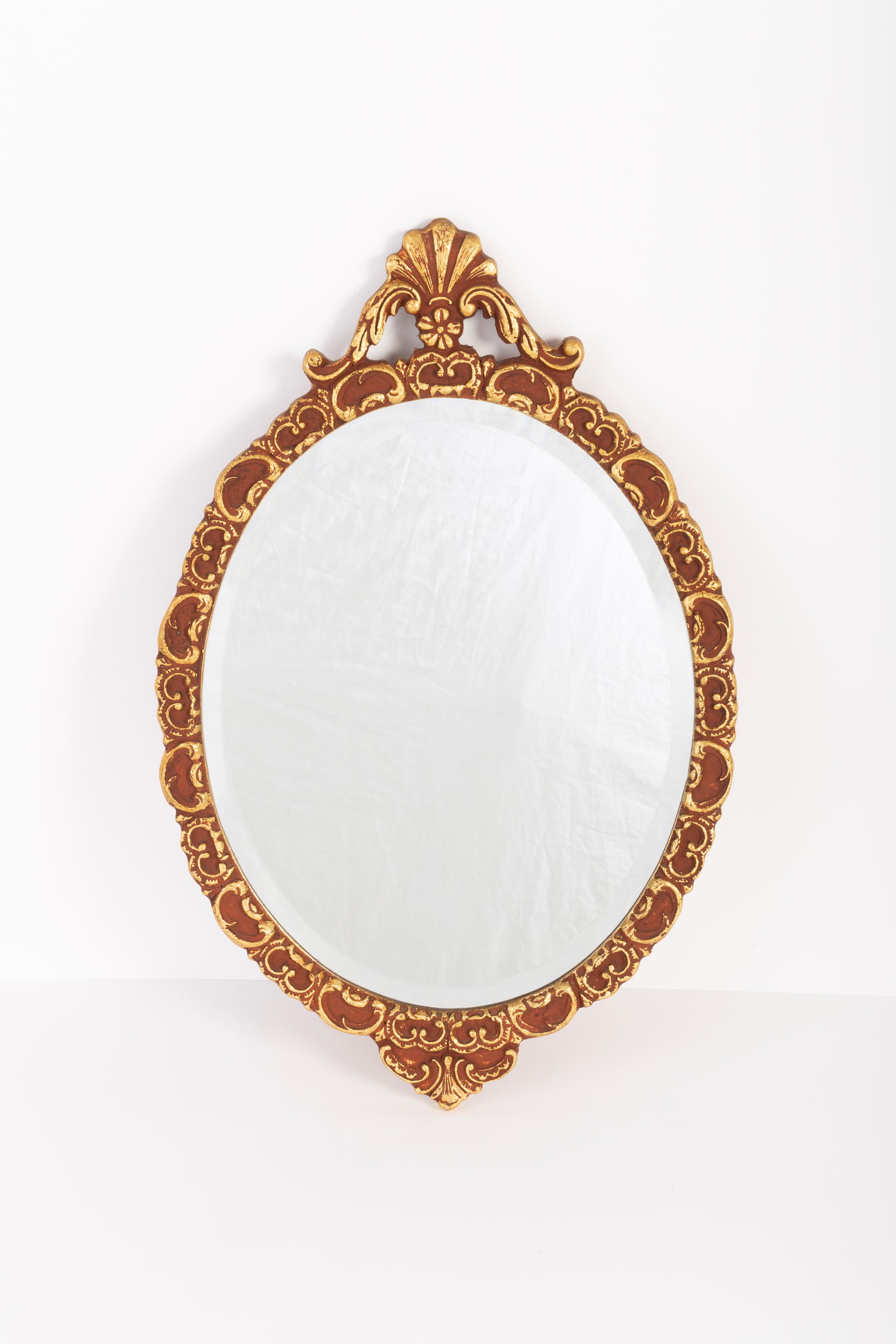 A mirror in a golden decorative frame from Italy. The frame is made of wood. Mirror is in very good vintage condition, no damage or cracks in the frame. Beautiful piece for every interior! Only one unique piece.