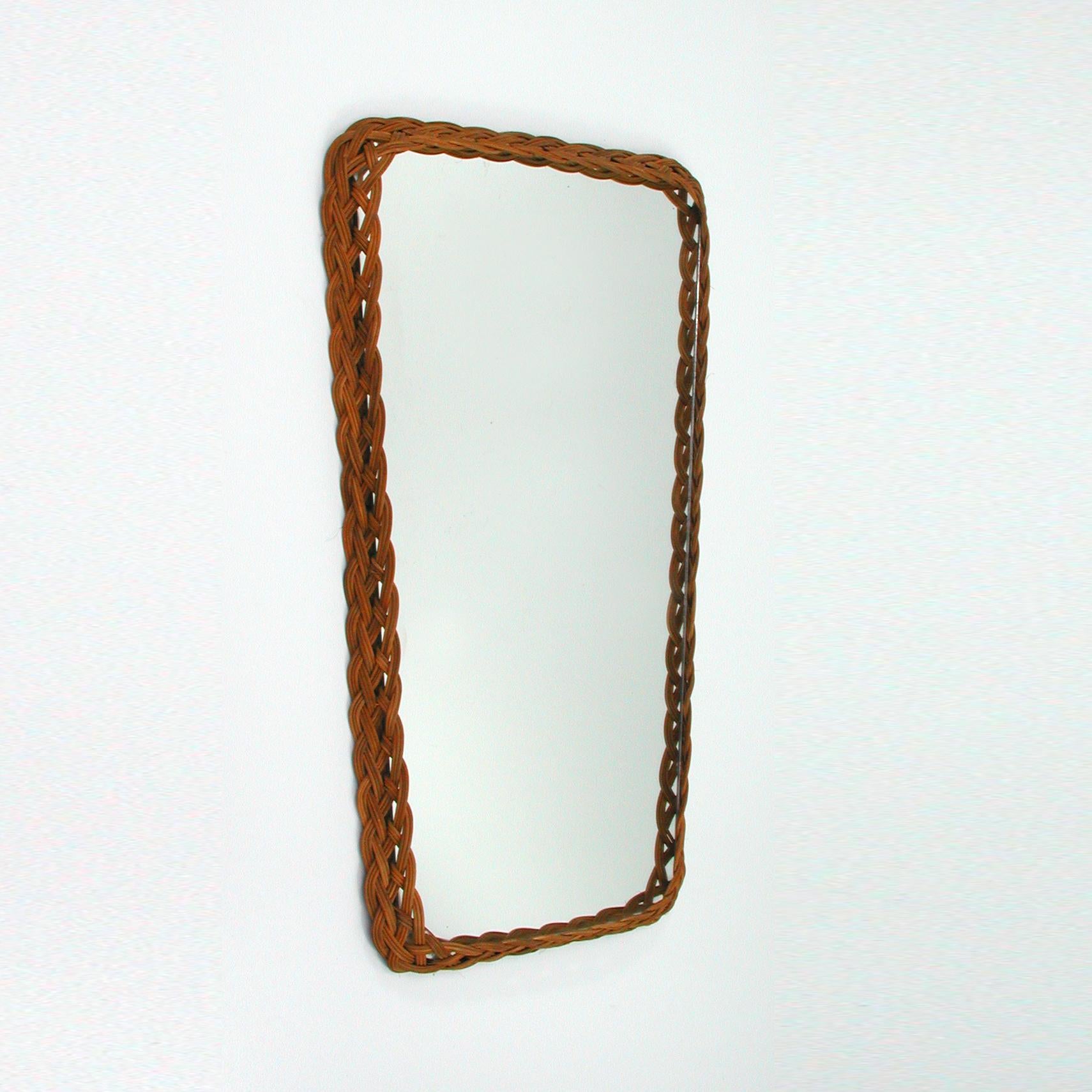 This vintage rattan wall mirror was made in France in the 1950s.
There is 1 mirror available.