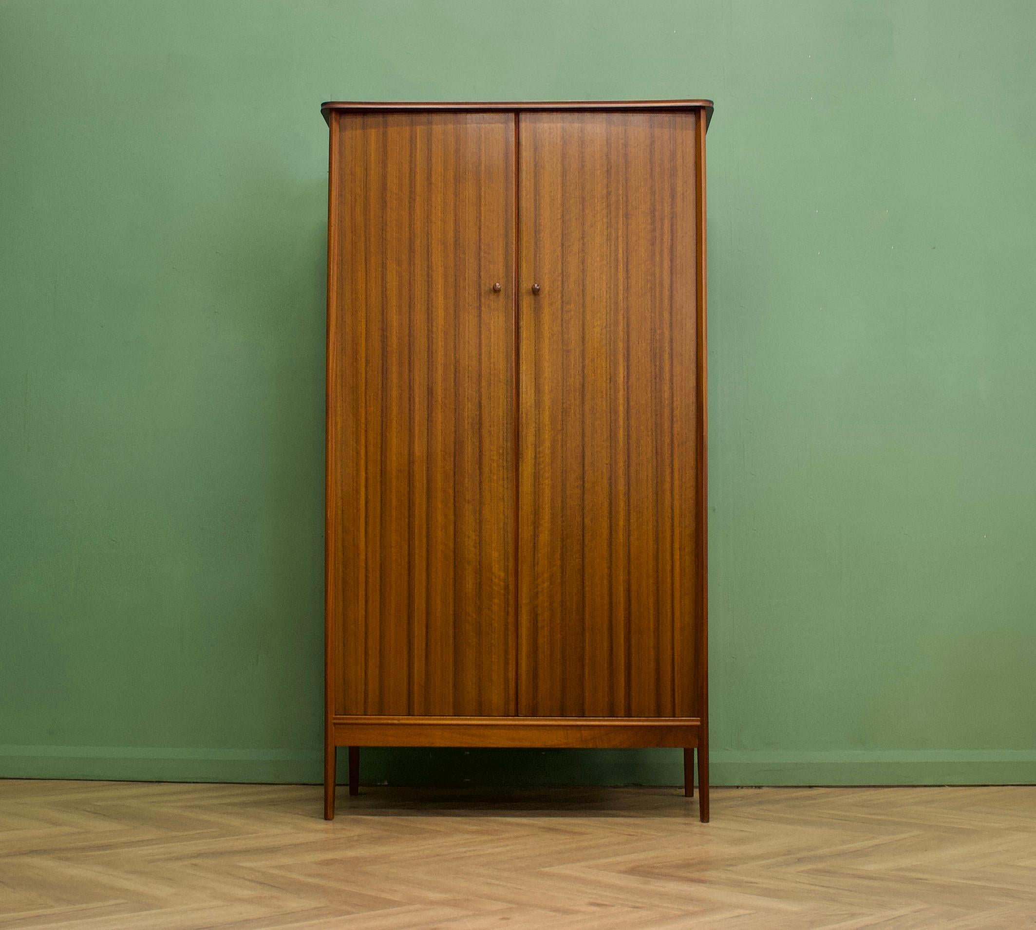 A walnut freestanding wardrobe designed by Peter Hayward for Vanson
Internally there is a clothes rail, shoe rail, drawers and a shelves
The attractive legs are slightly tapered and splayed