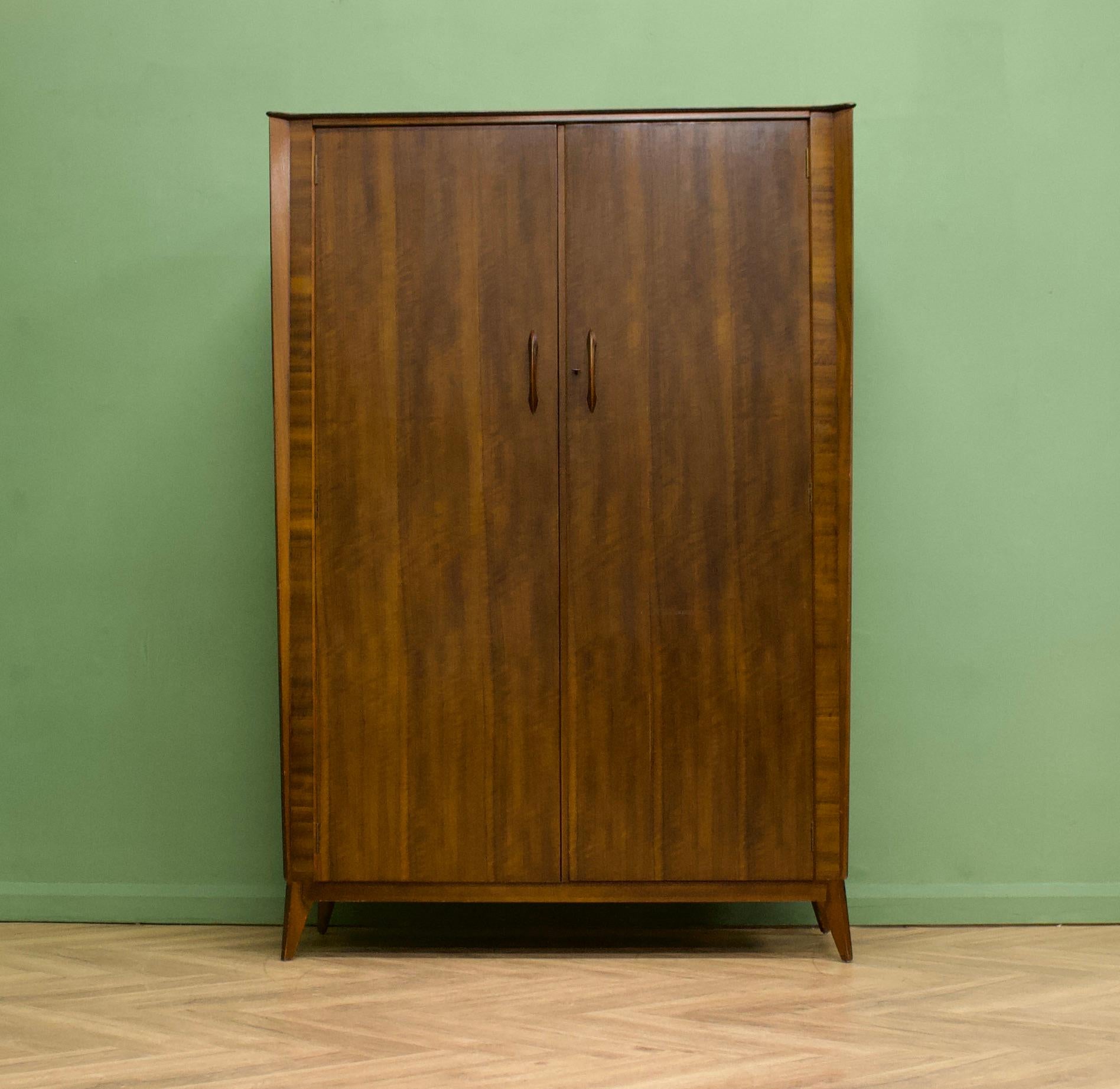 A walnut wardrobe from Waring and Gillow, circa 1950s
They were possibly one of the last pieces of furniture off the Lancaster factory's production line - before the company were taken over and the factory closed

It stands on splayed tapered legs -
