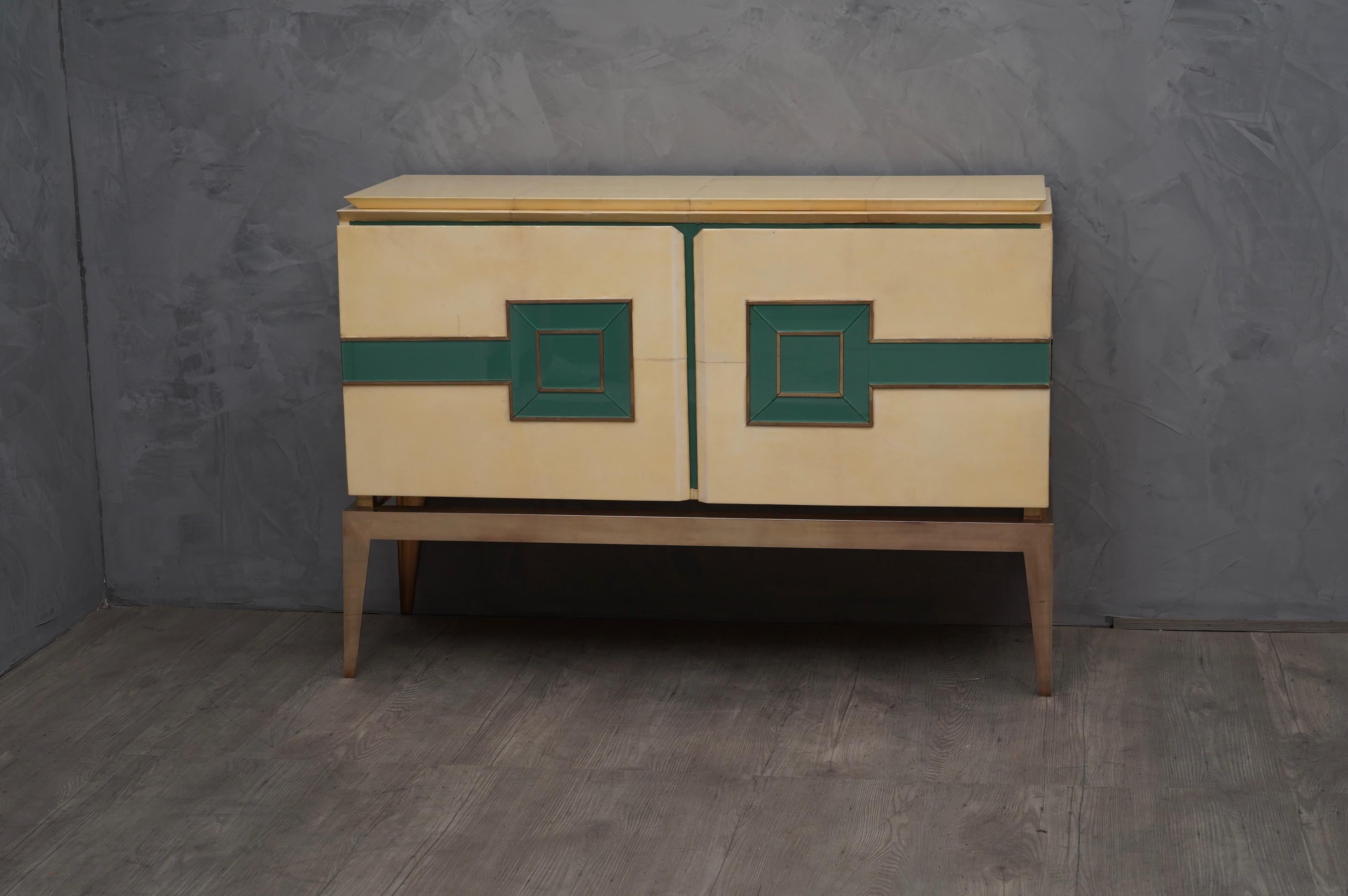 Bright colors and stylish look for this sideboard from the mid-20th century, design and materials of value, vitrified goatskin, glass and brass. An exaggerated elegance for this sideboard of Italian manufacture highly sought after, unfortunately not