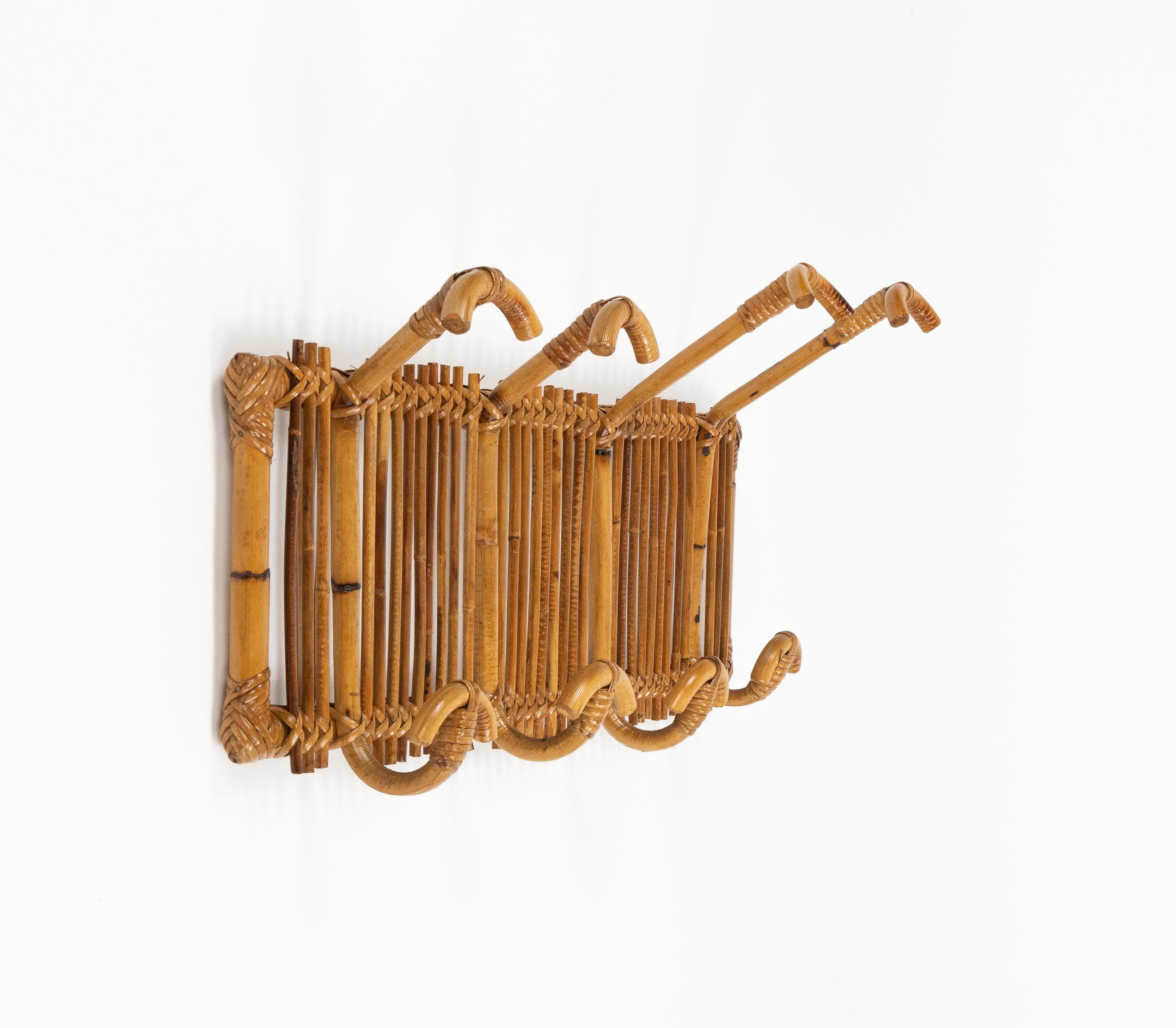 Midcentury beautiful wall coat rack in bamboo and rattan.

The piece was produced in Italy in 1960s and features a structure in bamboo canes and four rattan upper hooks and lower hooks for hanging clothes.   

The simple elegance of the lines,