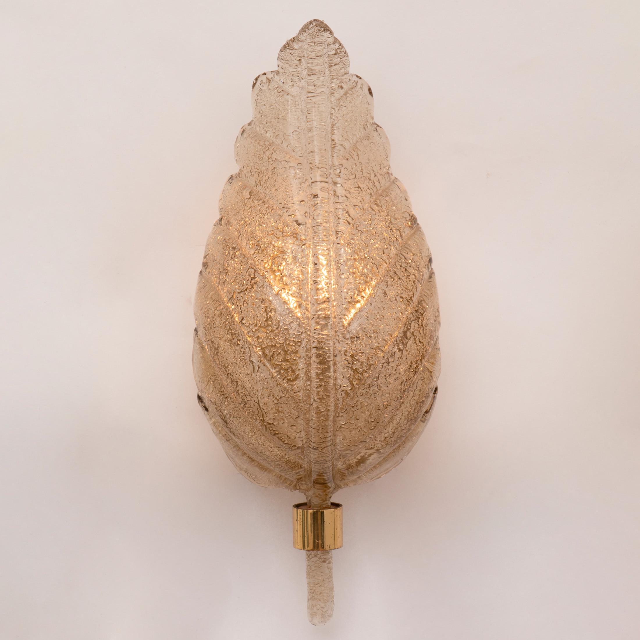 A pair of German Hillebrand wall lights feather formed smoked glass
Measures: H: 43 cm W: 18 cm D: 14 cm, 
Germany, circa 1960

We have 2 pairs available.