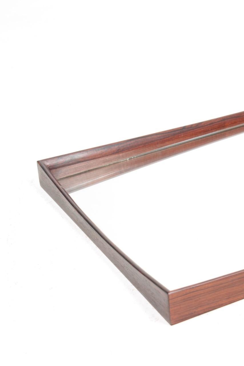 Wall mirror with frame in rosewood. Designed and made in Denmark. Great original condition.