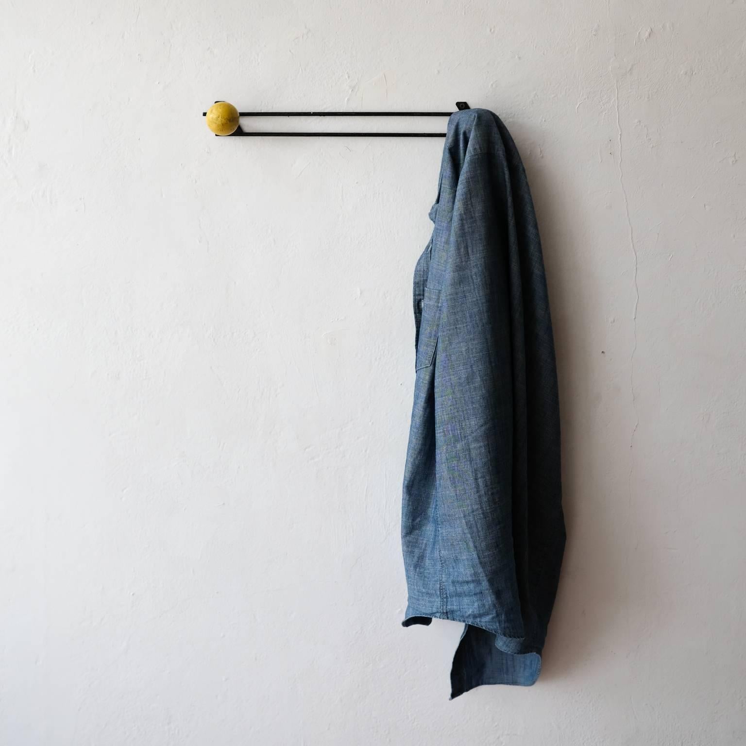 Wall-mounted coat rack. Iron and wood. Made in France, 1950s.
