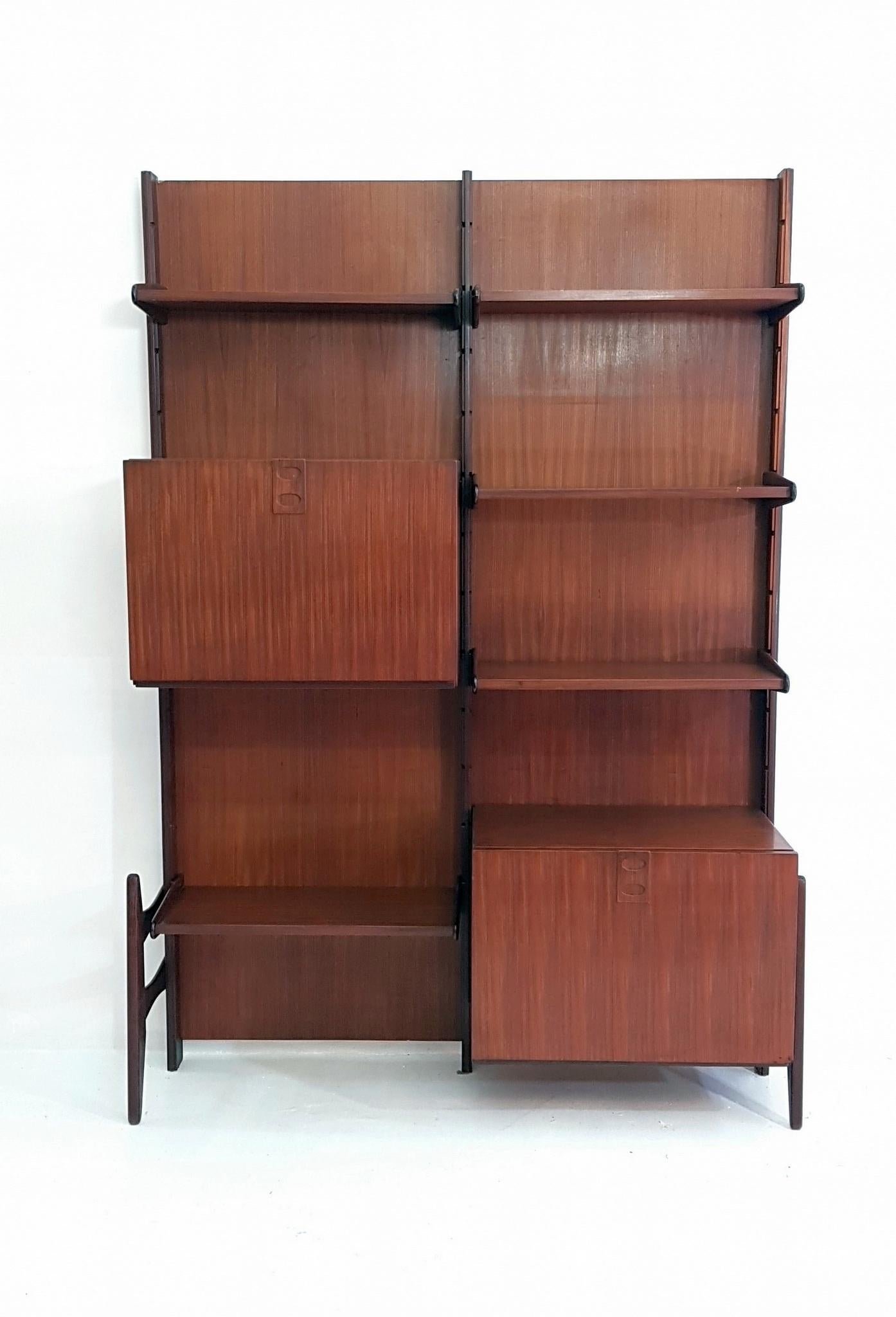 Step into the captivating world of Frattelli Proserpio's timeless craftsmanship with this exquisite 1960s teak wall unit. Created by the talented Proserpio brothers in their factory, which still thrives to this day, this freestanding marvel is sure