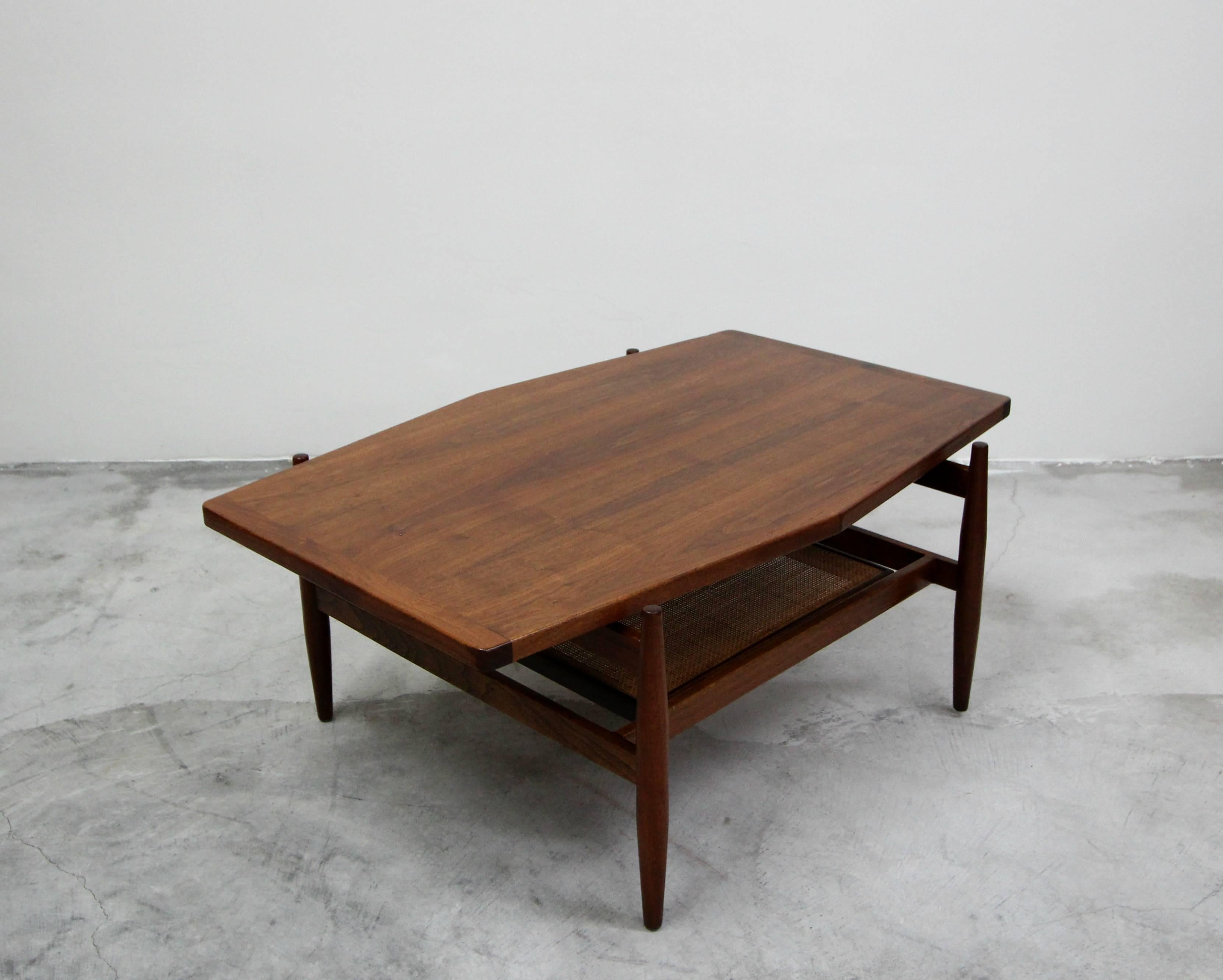 Beautiful hexagonal walnut and cane coffee table by Jens Risom. Simple midcentury design at it's finest. All original and in perfect condition.