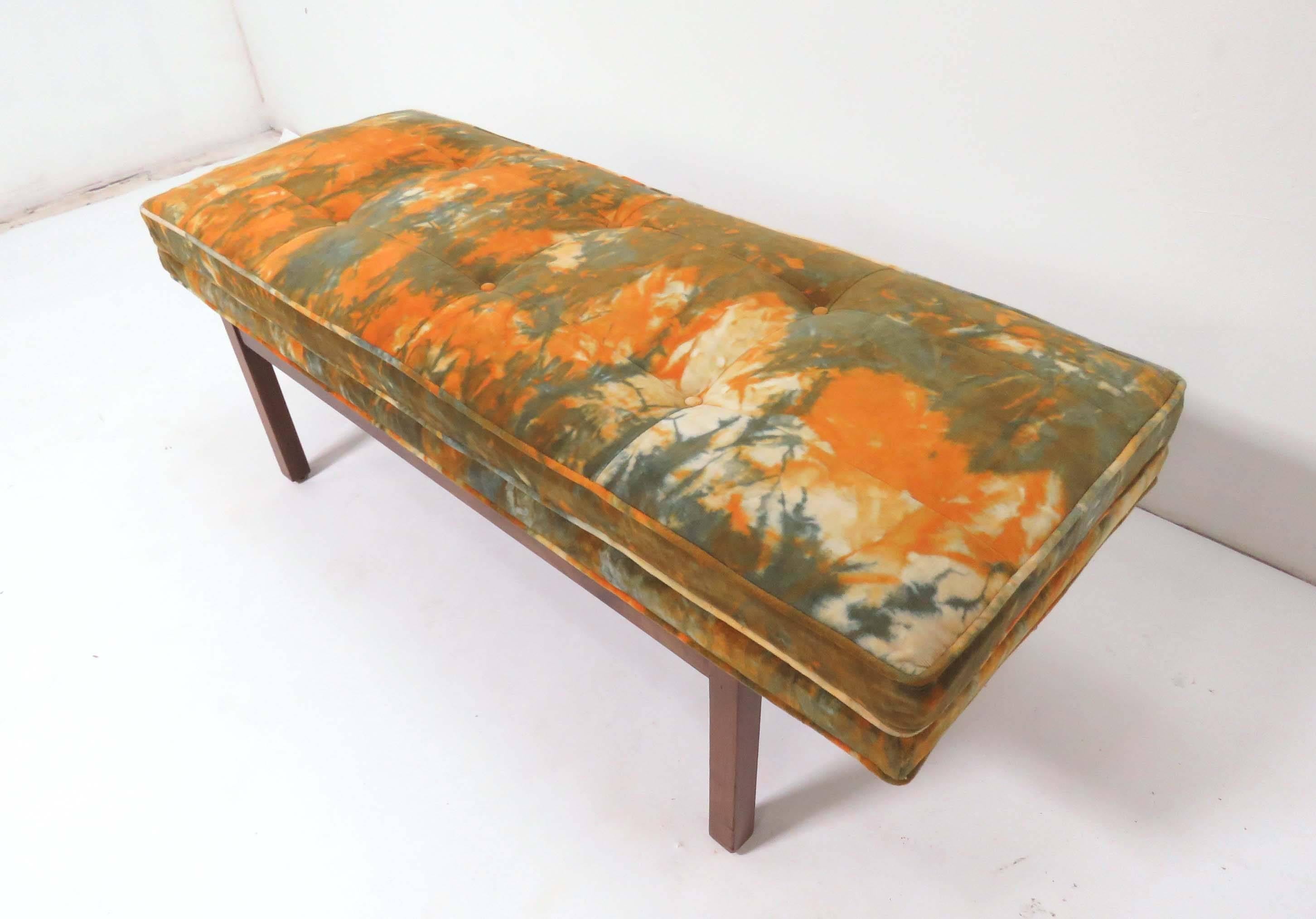 Mid-Century Modern bench with a walnut base, retaining its original velvet upholstery in an abstract floral tie-dye pattern reminiscent of the designs of Jack Lenor Larsen.