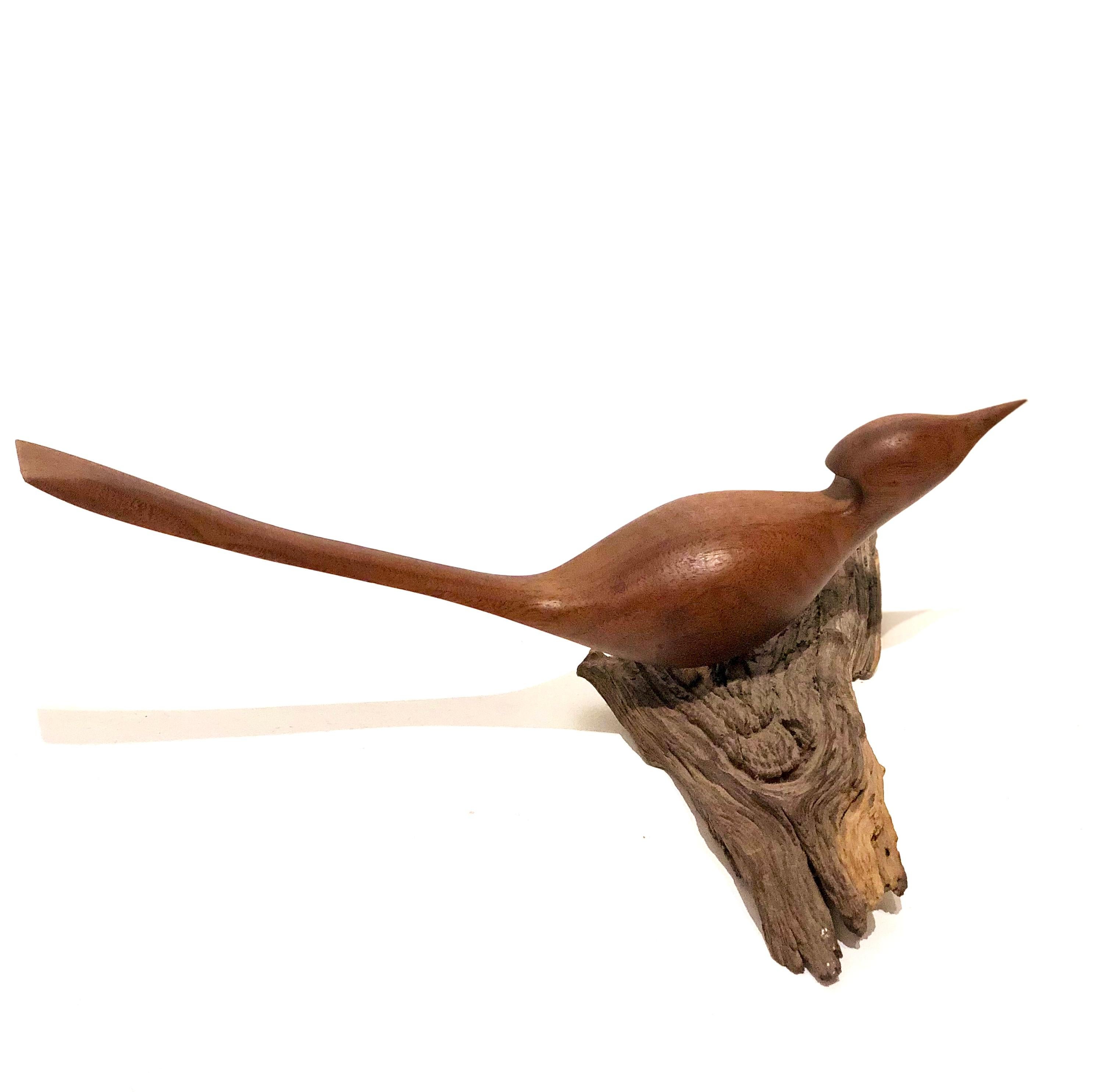 Vintage hand carved walnut bird sculpture on drift wood base, circa 1960s. Well done piece in great condition .