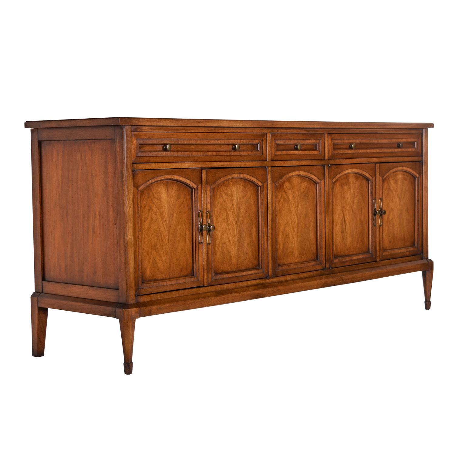 Midcentury walnut brass credenza sideboard by White Fine Furniture Company, circa 1968 from their Cosmopolitan line. Made of solid walnut wood with a fly speck finish. We lovingly and respectfully refer to this more traditional style as mid-century