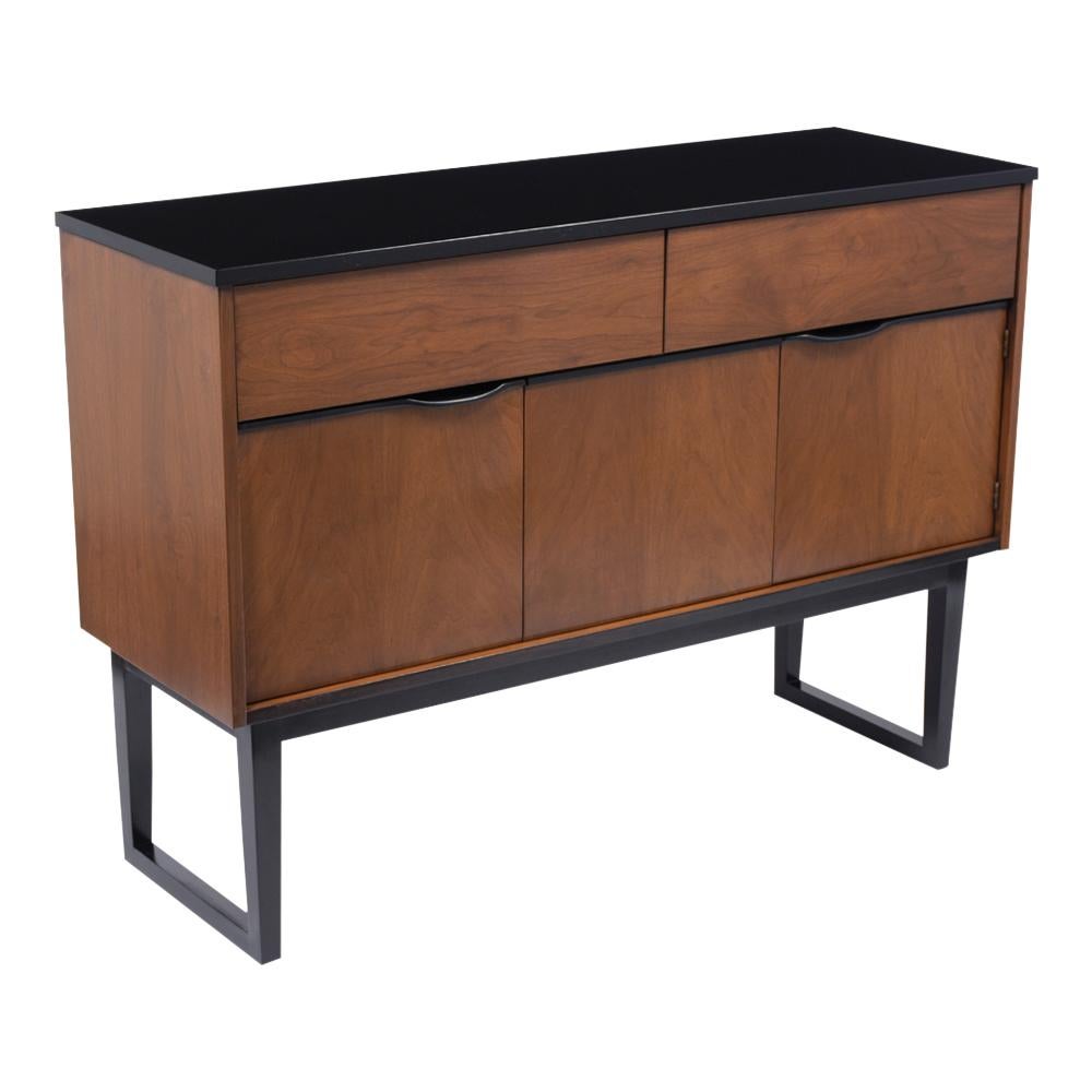A Vintage modern danish style credenza that has been fully restored, is made out of walnut wood and has been stained in a new walnut & ebonized color combination with a lacquered finish. This fabulous piece features a double door with plenty of