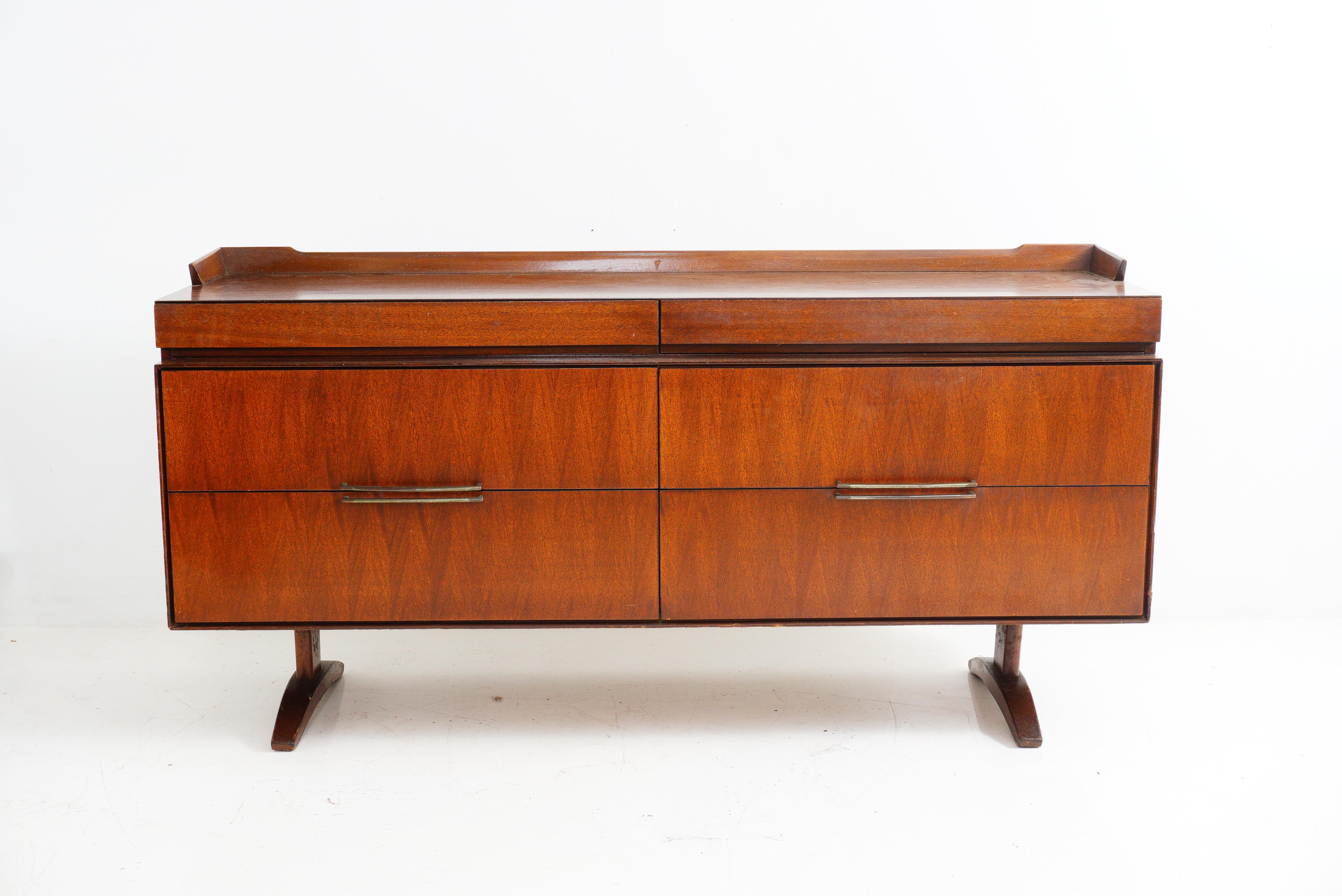 A Mid-Century Modern sideboard that effortlessly combines sleek lines and warm charm. Crafted from rich walnut, this sideboard brings both functional storage and a touch of retro sophistication to your space. Elevate your décor game with a nod to