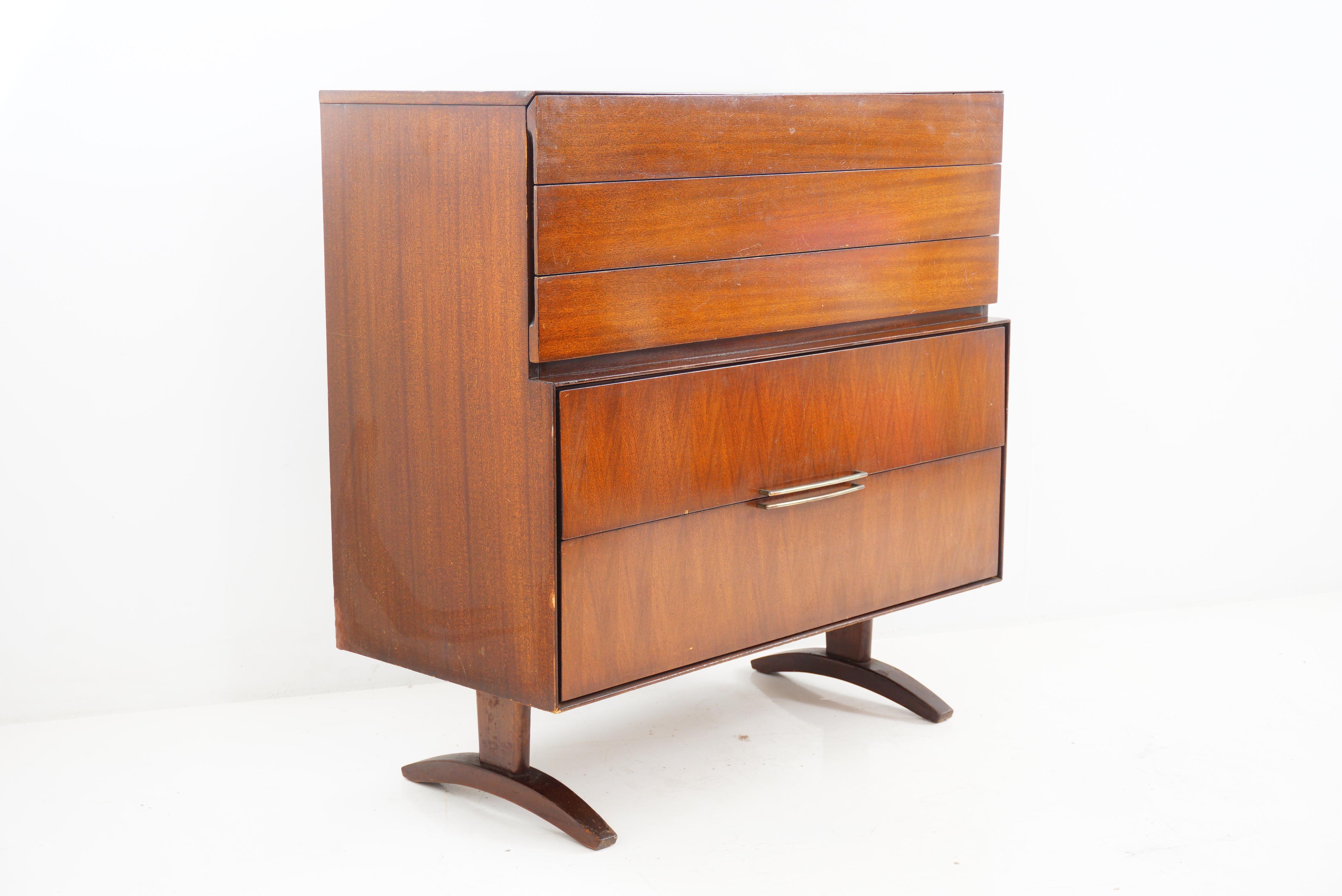 A Mid-Century Modern highboy that adds a hefty dose of style to your space. Crafted from lustrous walnut, this sleek highboy is more than just storage; it's a statement piece that effortlessly bridges the gap between function and sophistication.

-