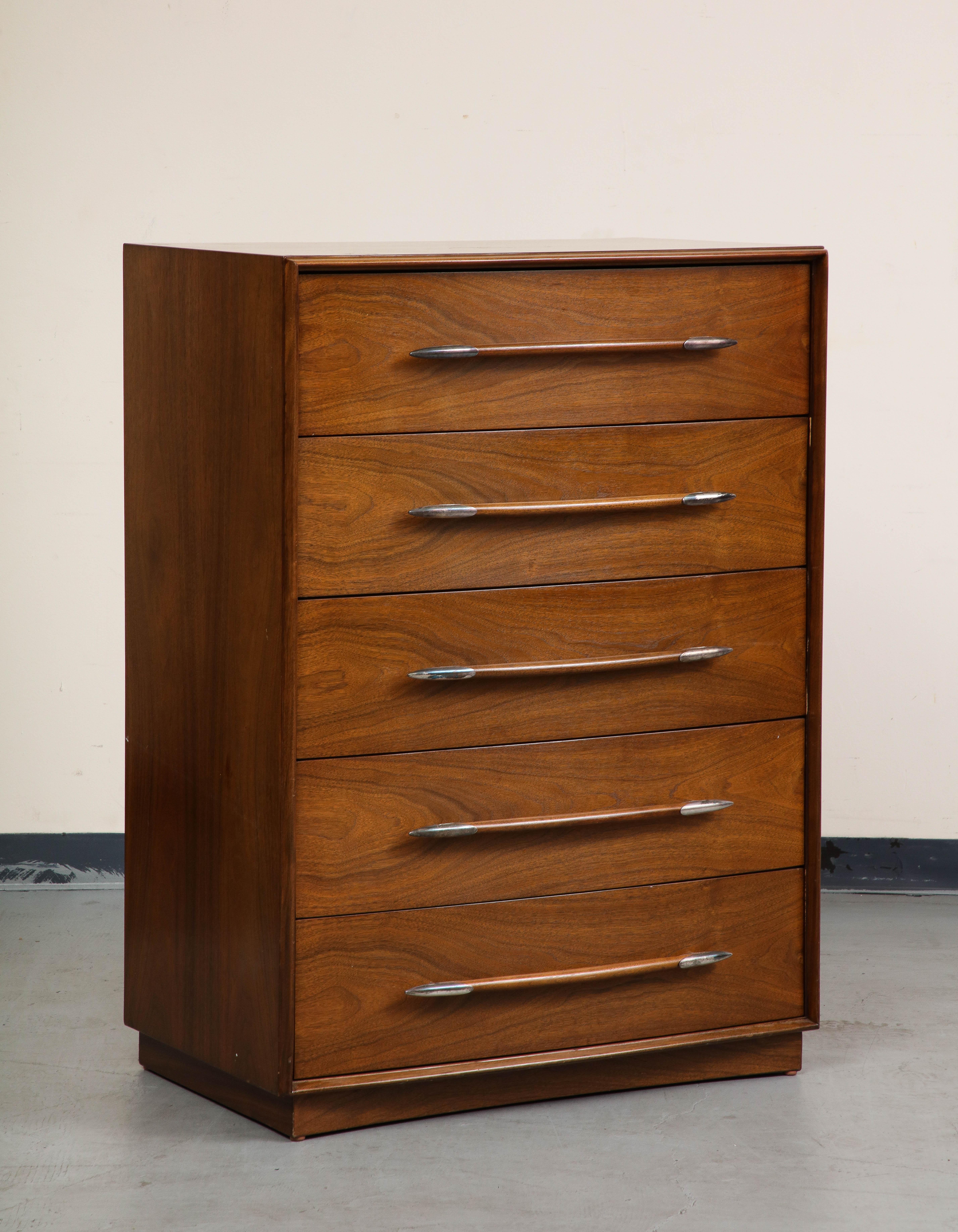 Classic midcentury walnut high bureau dresser with five drawers, featuring unique spear-shaped pulls with nickel-tipped ends. 

Designed by T.H. Robsjohn-Gibbings for The Widdicomb Furniture Company, 1950s. 

47