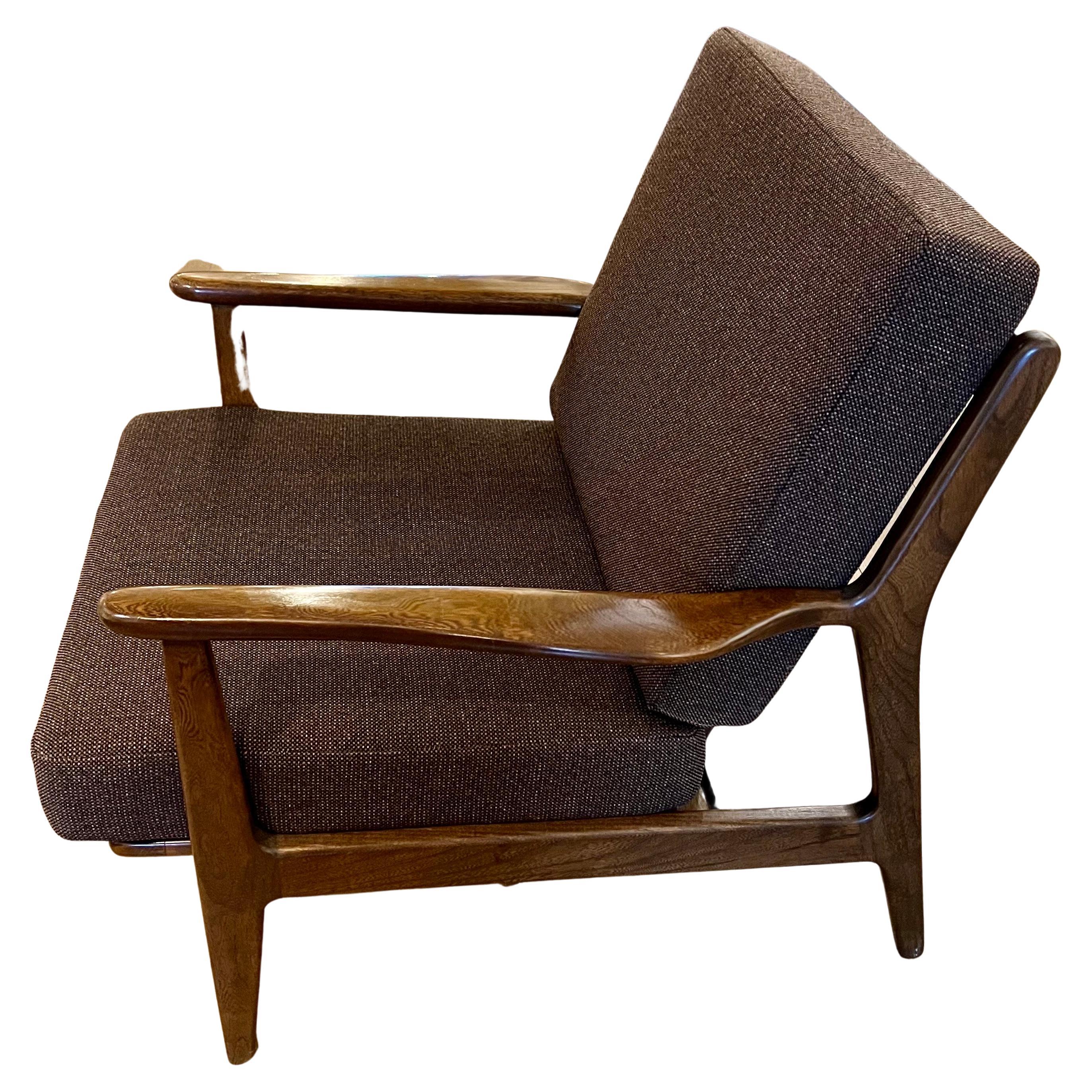 Beautiful American MCM walnut lounge chair by Viko Baumritter for Baumritter of New York, circa the 1960s. The frame is in excellent condition and are very sturdy and solid. The chairs feature a spindle back, and sculpted armrests we have recovered