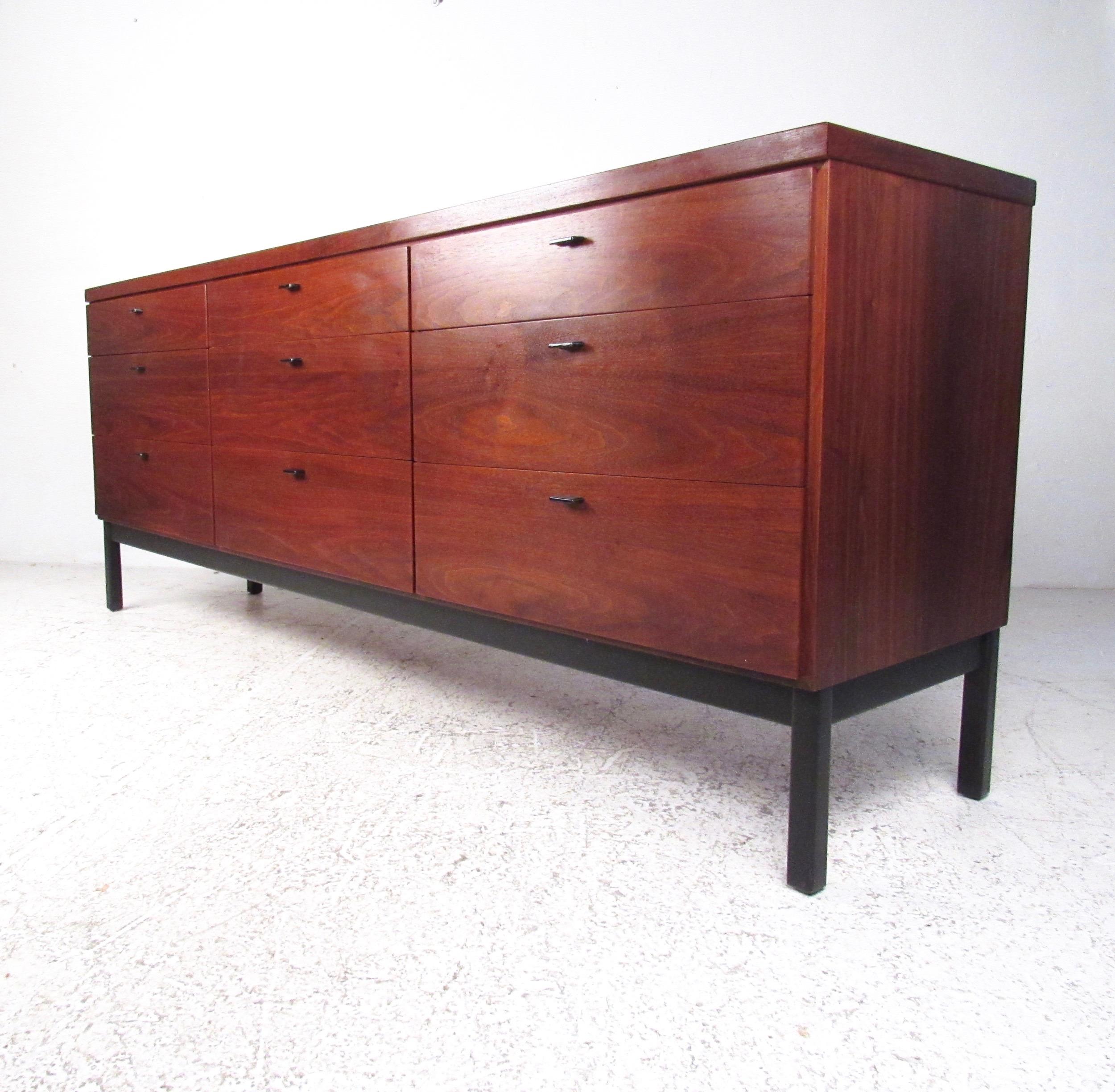 This beautiful Mid-Century Modern dresser features striking natural finish, dovetailed drawers, and unique Florence Knoll style drawer pulls. Nine spacious drawers offer plenty of storage for bedroom storage, although the impeccable vintage walnut
