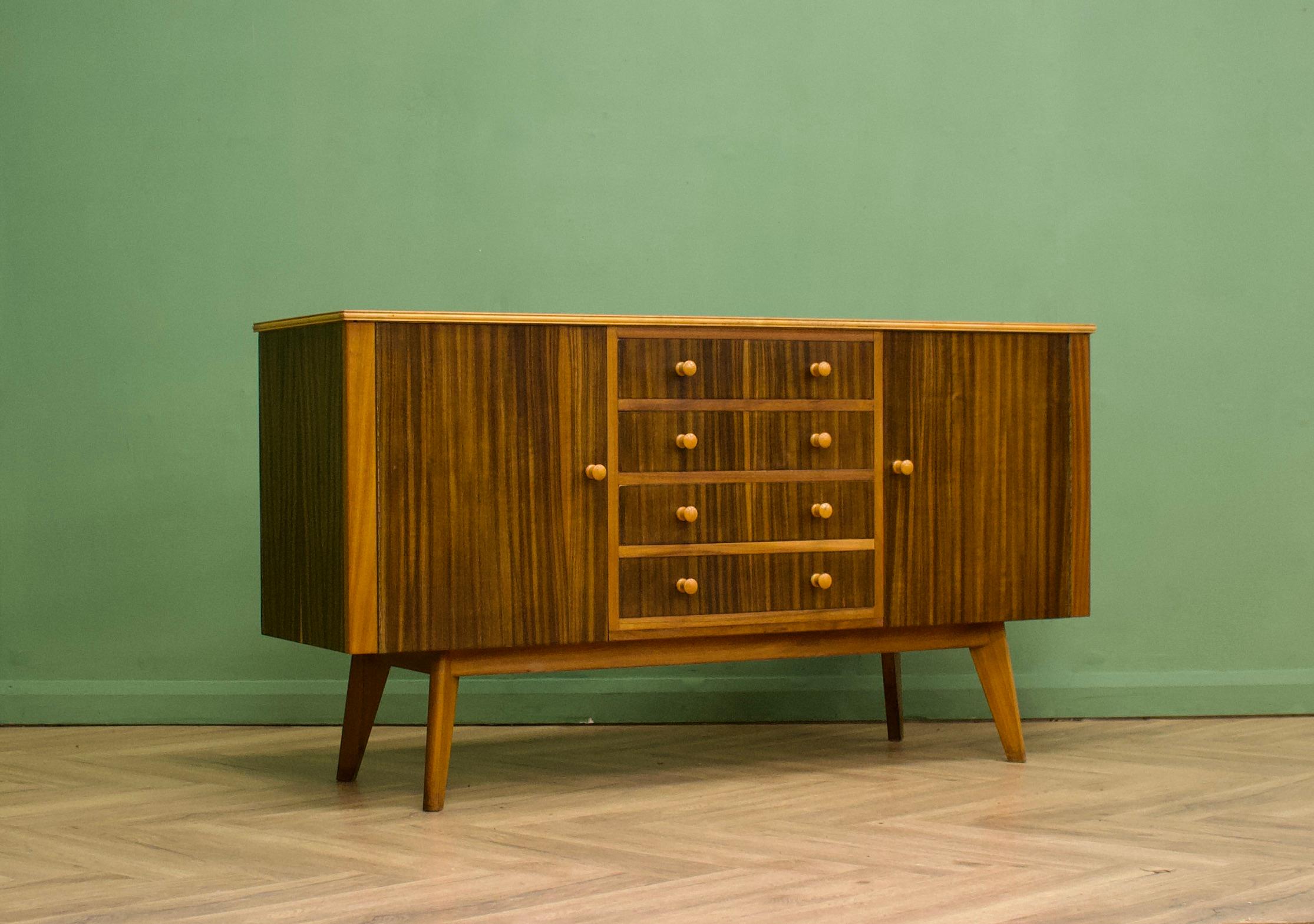 A walnut sideboard from Morris of Glasgow - designed by Neil Morris for the Cumbrae range

The attractive legs are slightly tapered and the handles are solid wood

Featuring two cupboards - with removable shelves and three drawers