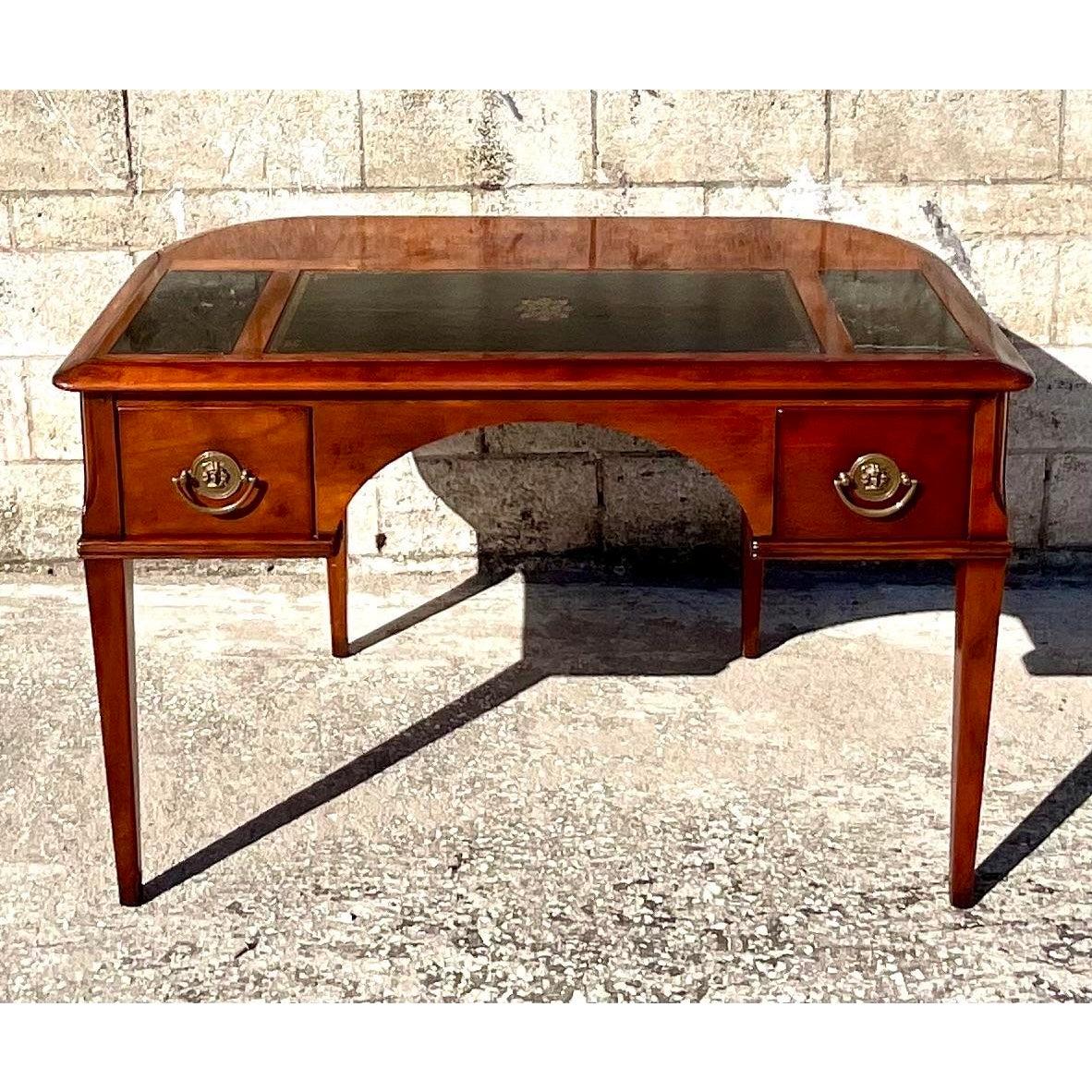 Incredible Midcentury writing desk. Beautiful inset Carrera marble and leather panel with embossed gold leaf detail. Pull out trays and hidden pull out partners writing table. Marquetry details along the front. Acquired from a Palm Beach estate.