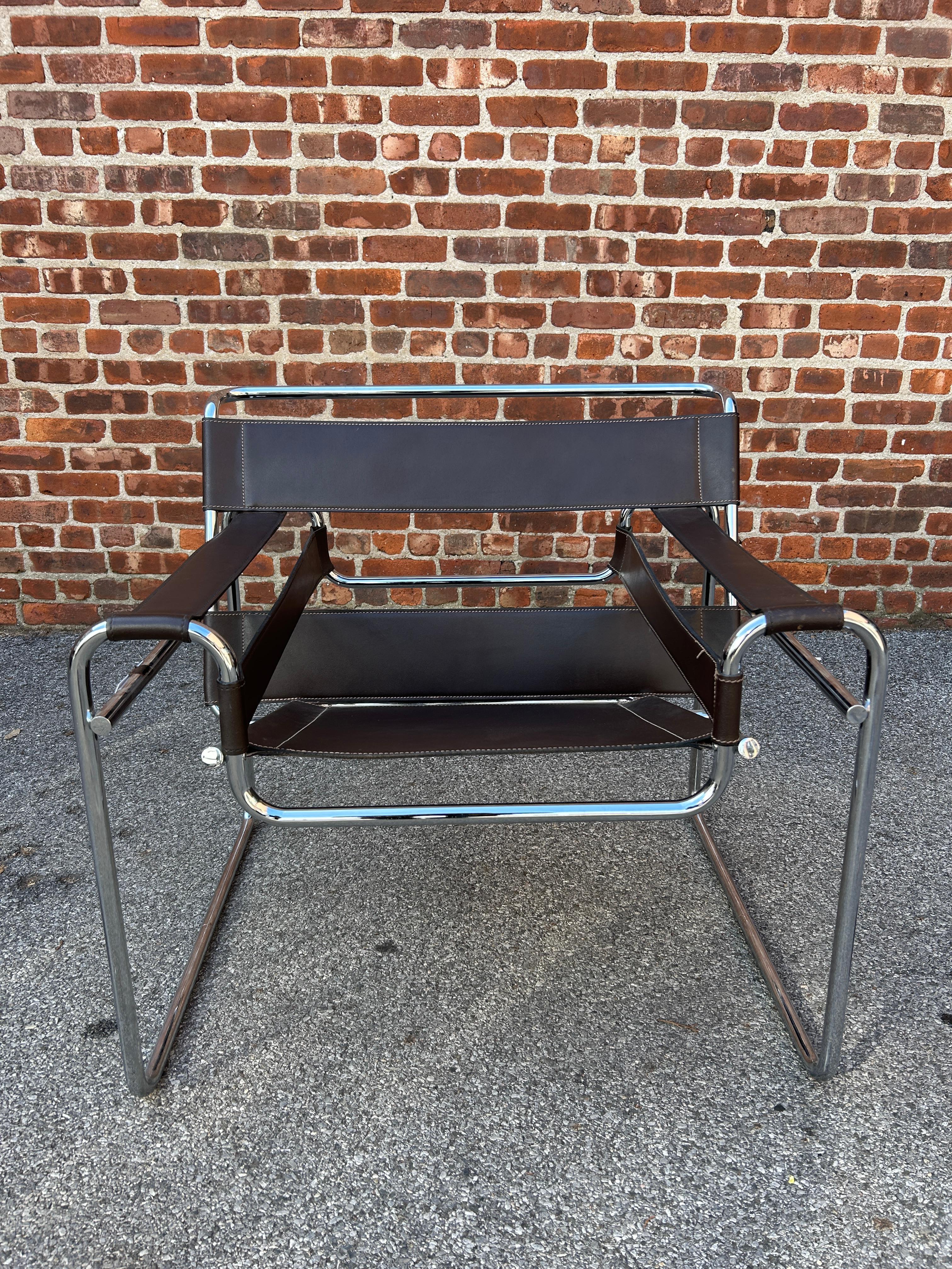 Wassily lounge chair designed by Marcel Breuer in brown full leather. This vintage chair has the traits for authenticity verification such as flat caps on the end tubes, black hex screws and brown leather with stitching. 

Listing is for (1) chair