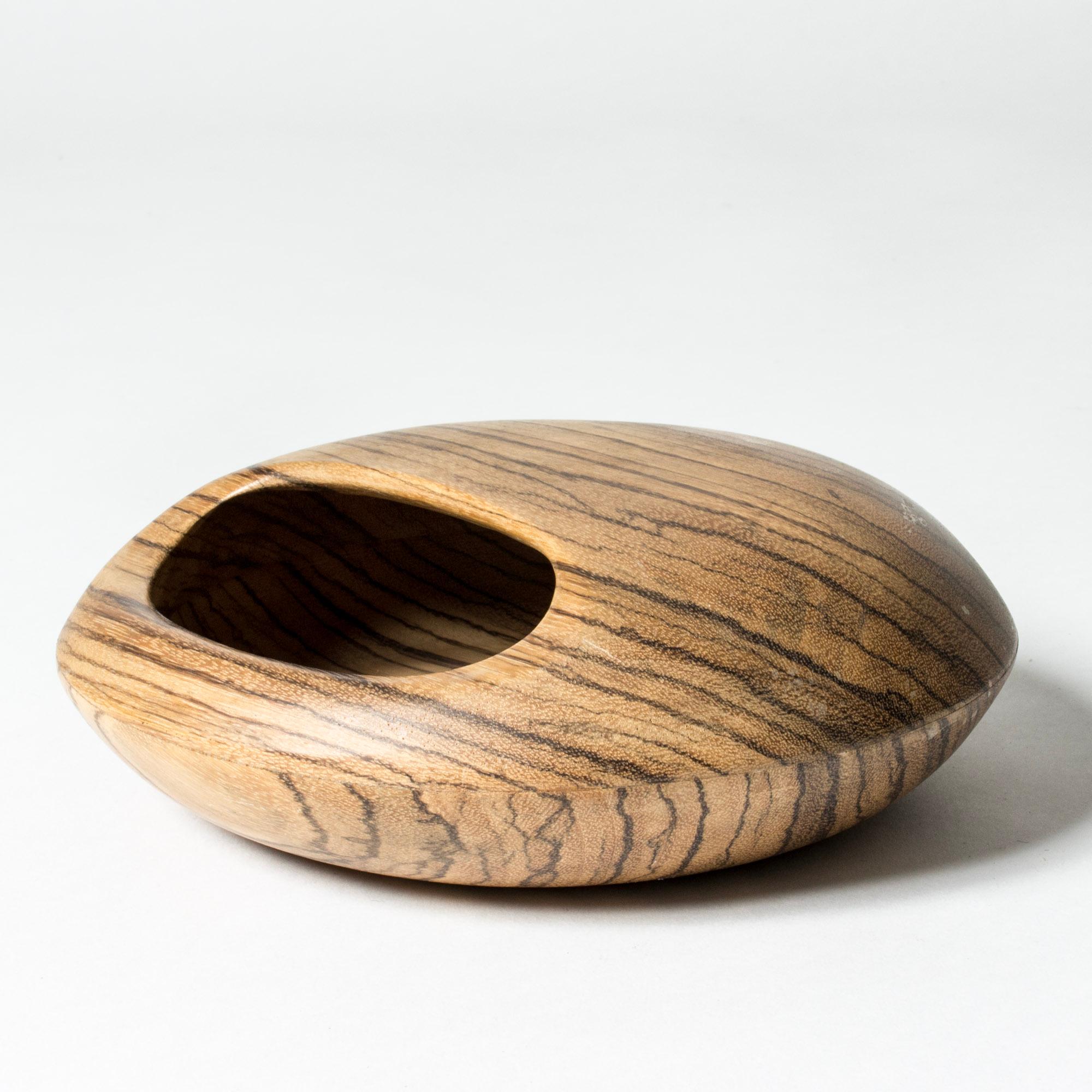 Striking wenge “nut cache” bowl by Sigvard Nilsson, in a convex, smooth round form with an oval opening. Very decorative and sculptural.