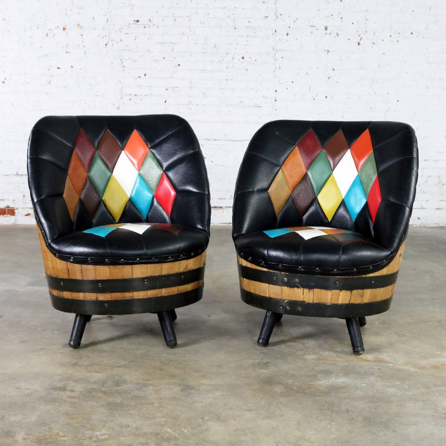 An awesome pair of midcentury mod swivel barrel chairs literally made of whiskey barrels by Brothers of Kentucky. They are upholstered in Naugahyde with a sewn in diamond somewhat argyle pattern upholstery. The barrels are in perfect condition. The