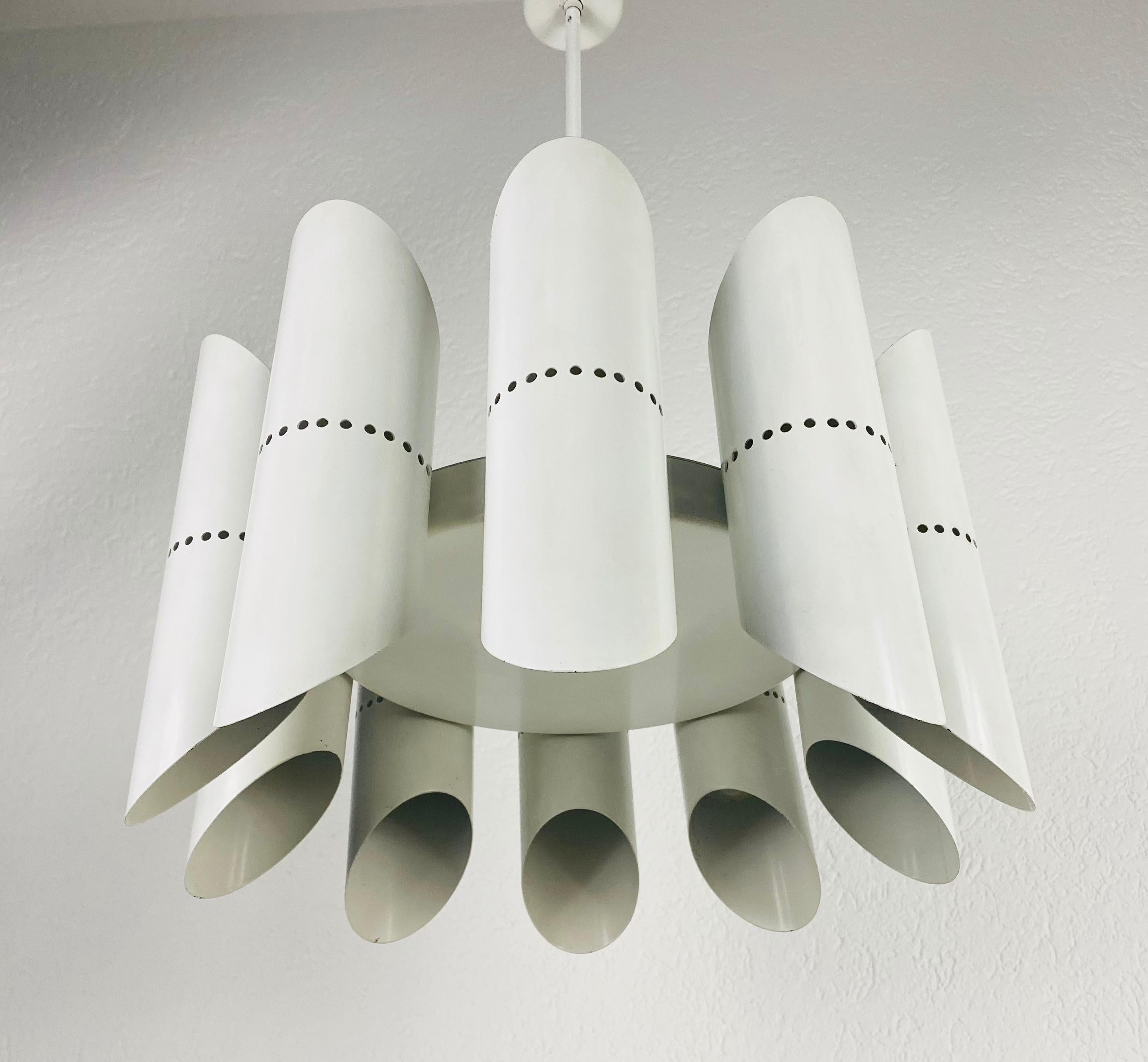 A midcentury chandelier made in the 1960s. It is fascinating with its Space Age design and ten arms. The white circular body of the light is made of full metal, including the arms. White bar with white canopy.


The light requires 10 E14 light