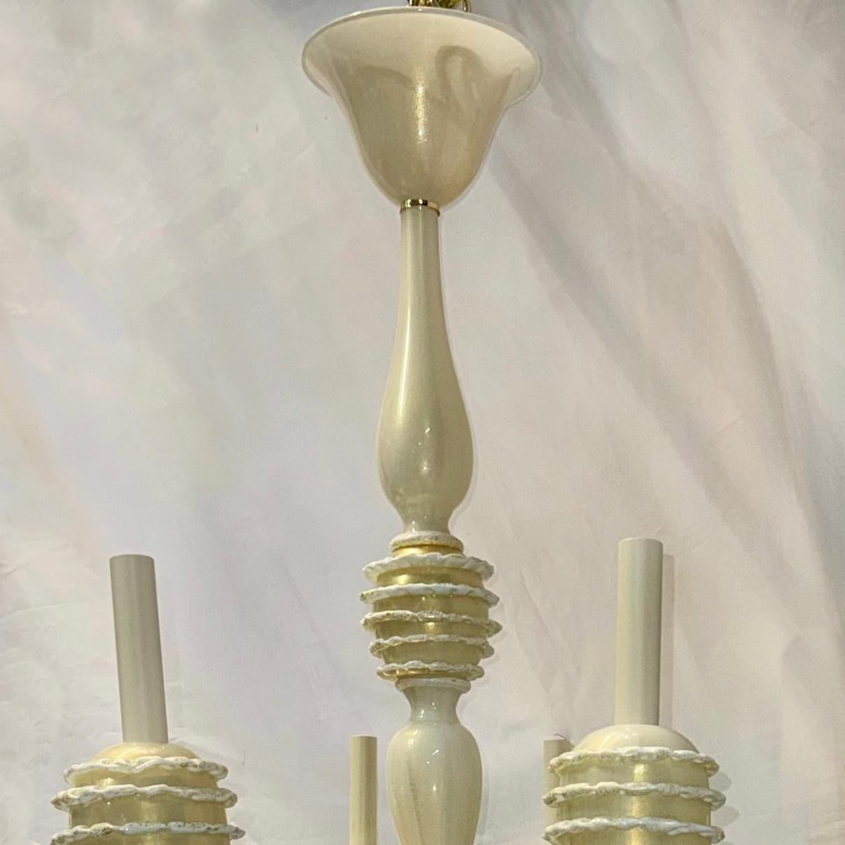 A circa 1960's Italian cream white chandelier with gold insets with 8 candelabra base lights .

Measurements:
Diameter: 32