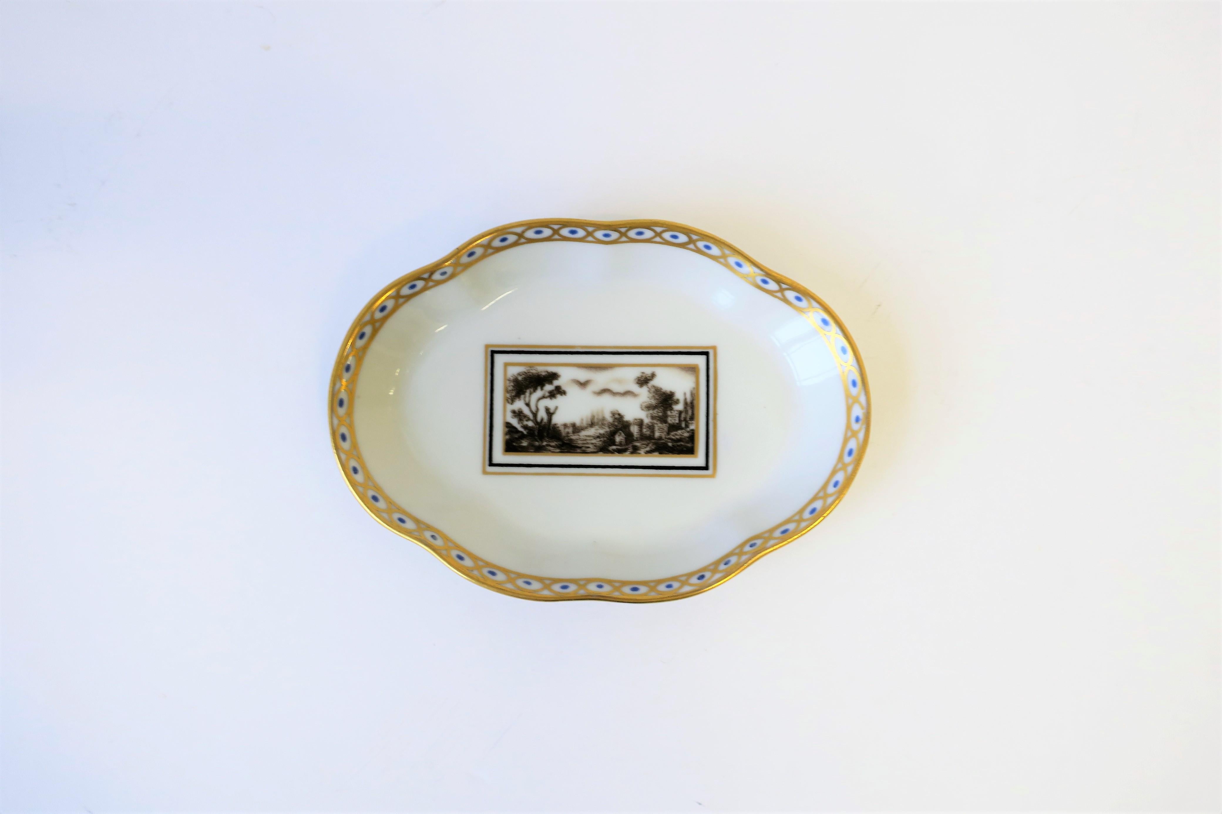 A beautiful midcentury Italian oval dish by designer Richard Ginori, circa Mid-20th Century, Italy. Dish has decorative gold and blue detail around edge, and center area featuring a forest or pasture scene, squared off with a black and gold