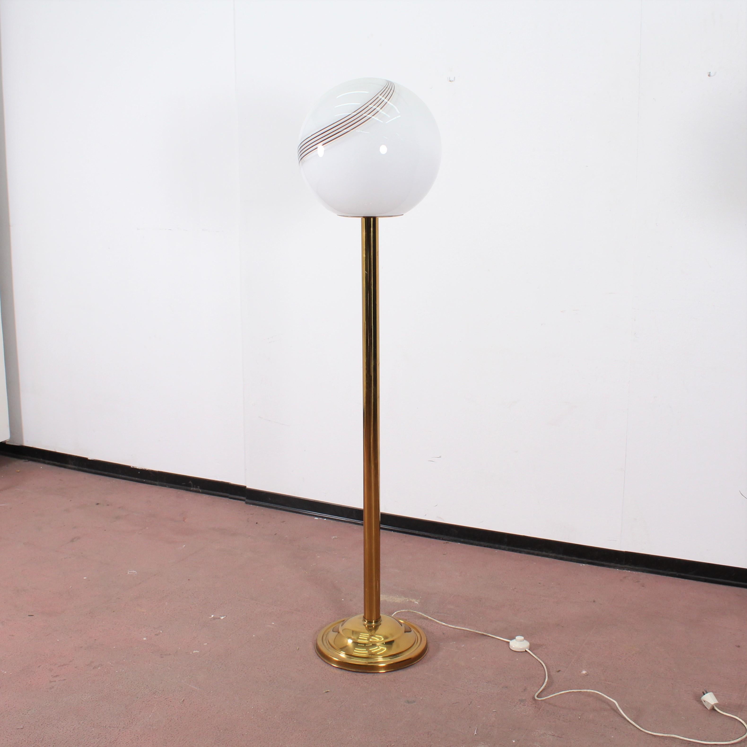 Beautiful floor lamp designed and manufactured in Italy in 1970s. The lamp is made of golden metal and white opaline globe glass with colored stripes.
Wear consistent with age and use.