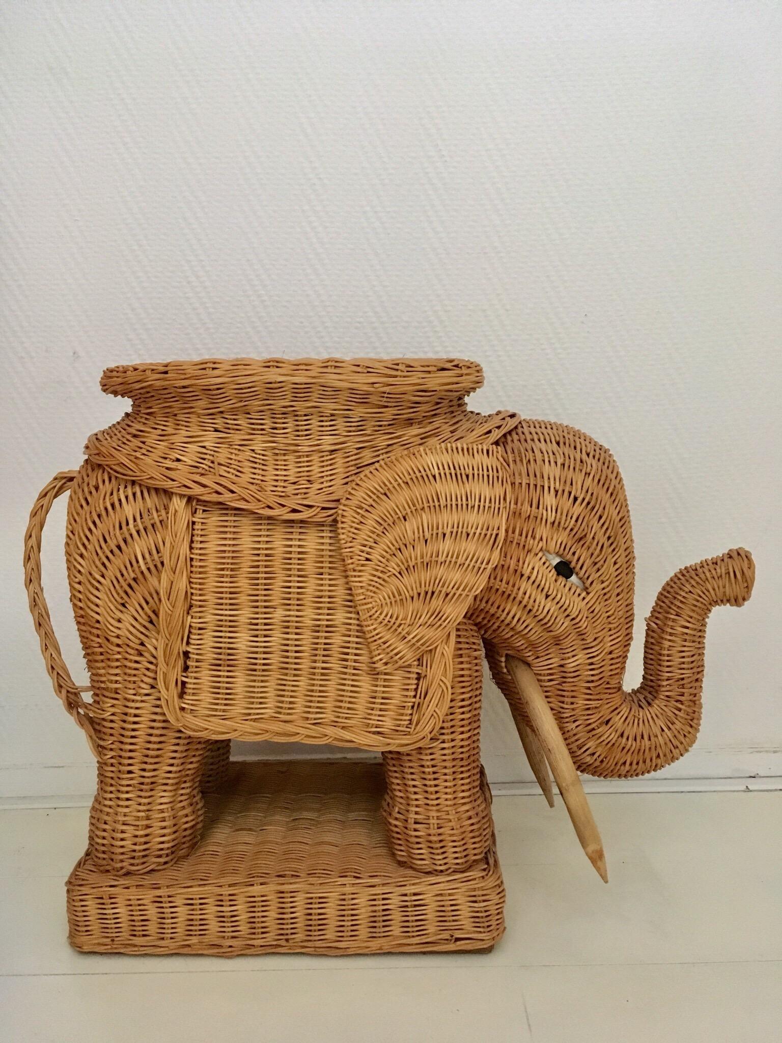 Wonderful midcentury wicker elephant remains in excellent condition. Measurements: H 49 x L 65 x D 24 cm. Top surface 32 x 25 cm.