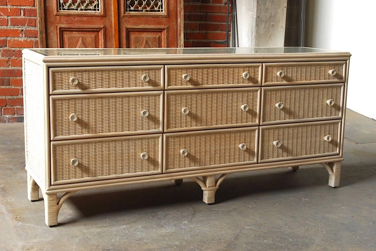 Mid-Century Modern dresser by Whitecraft for Woodard Furniture Company. Constructed from woven wicker and rattan with a painted finish. The case and drawers are bordered with split rattan and the top has a fitted pane of glass. The drawers have