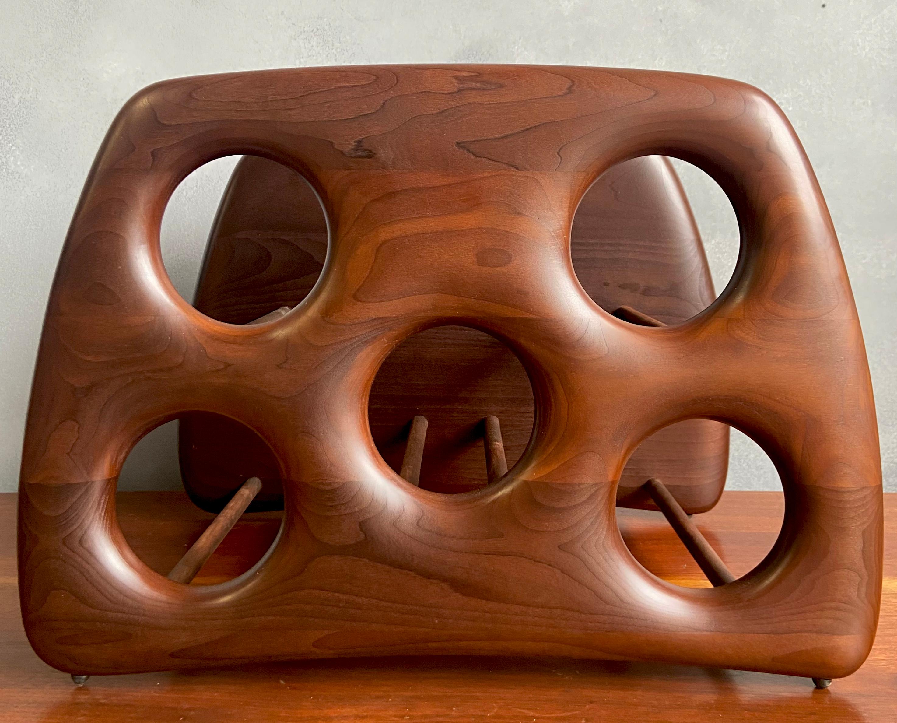 Nous vous présentons ce magnifique porte-bouteilles sculpté par le maître artisan Dean Santner. Les créations de Santner font partie du mouvement American Modern Craft, aux côtés de Wendell Castle, Nakashima, Phillip Powell, pour n'en citer que