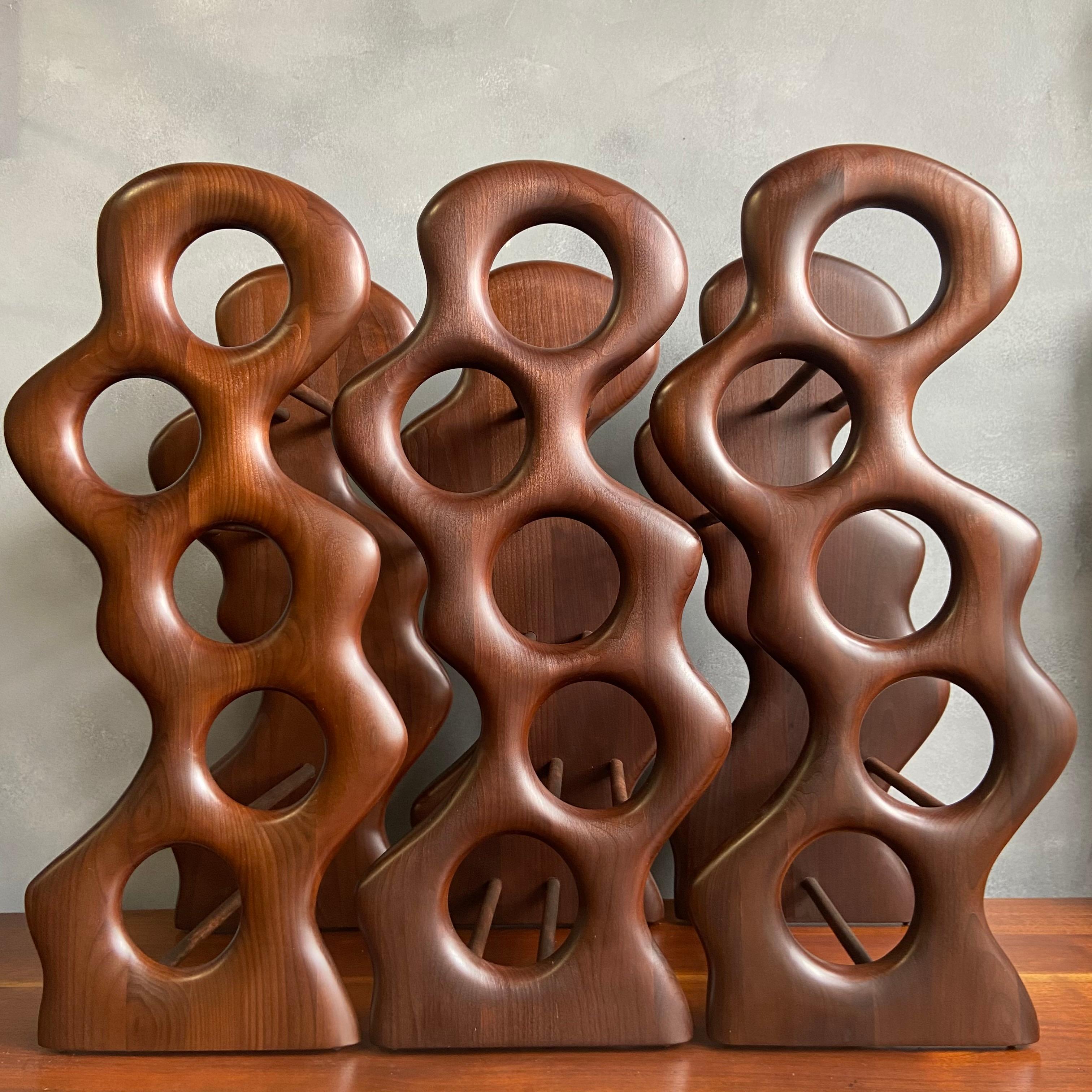 For your consideration are these beautifully sculpted wine racks by Master Craftsman Dean Santner. Santner designs are part of the American Modern Craft movement along side Wendell Castle, Nakashima, Phillip Powell to name a few. This hand sculpted