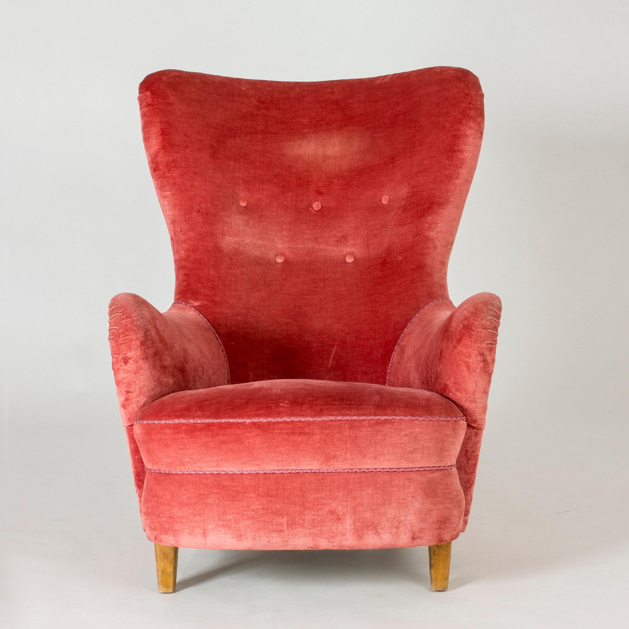 Swedish midcentury wingback lounge chair. Beautiful design with generous curves. Original upholstery in vibrant pink velvet.