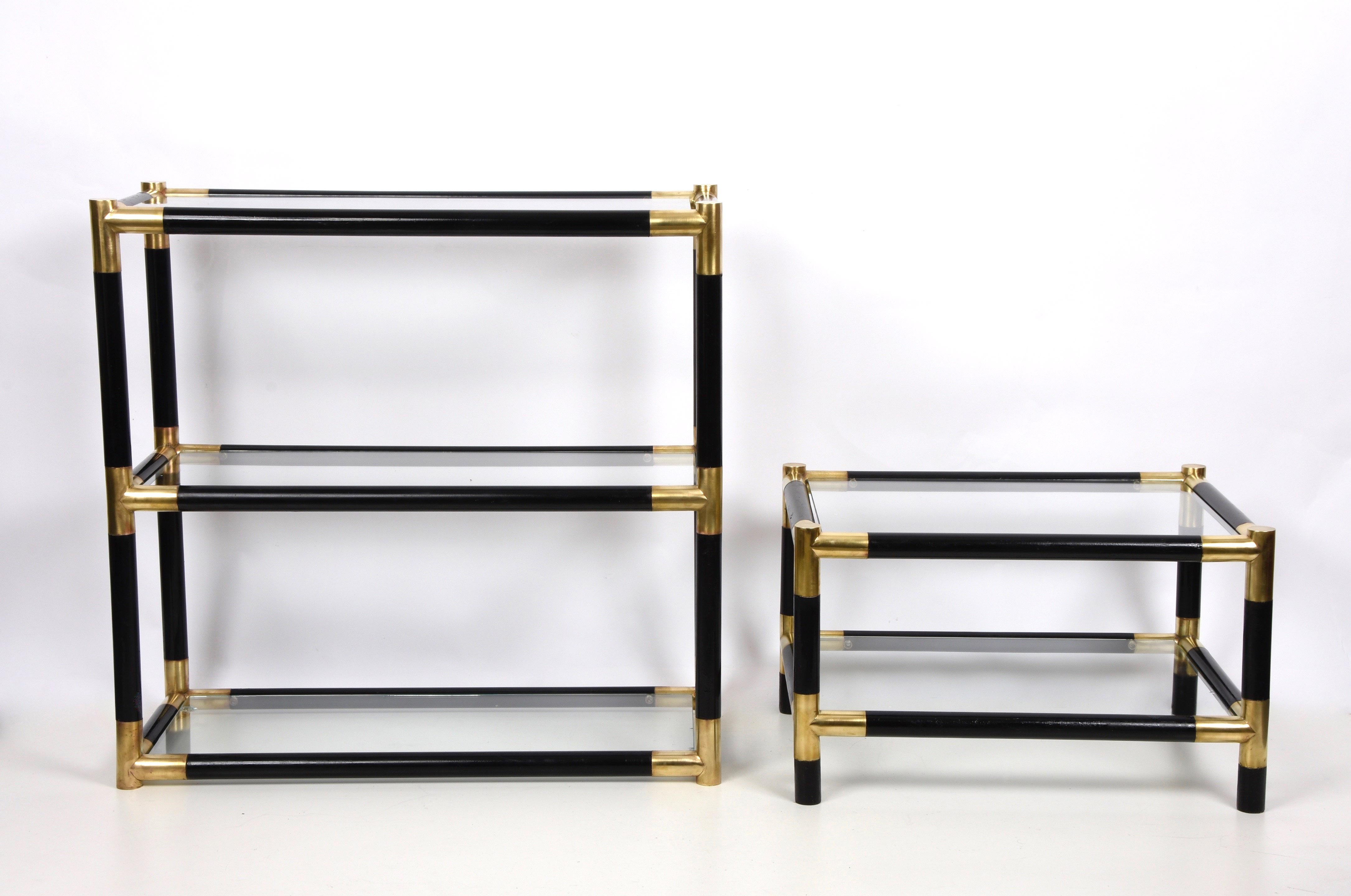 Amazing midcentury bookcase in lacquered black wood with half-century brass and three crystal shelves. This fantastic bookcase was produced in Italy during the 1970s. 

This bookcase or étagère conveys elegant and delicate feelings. This piece is