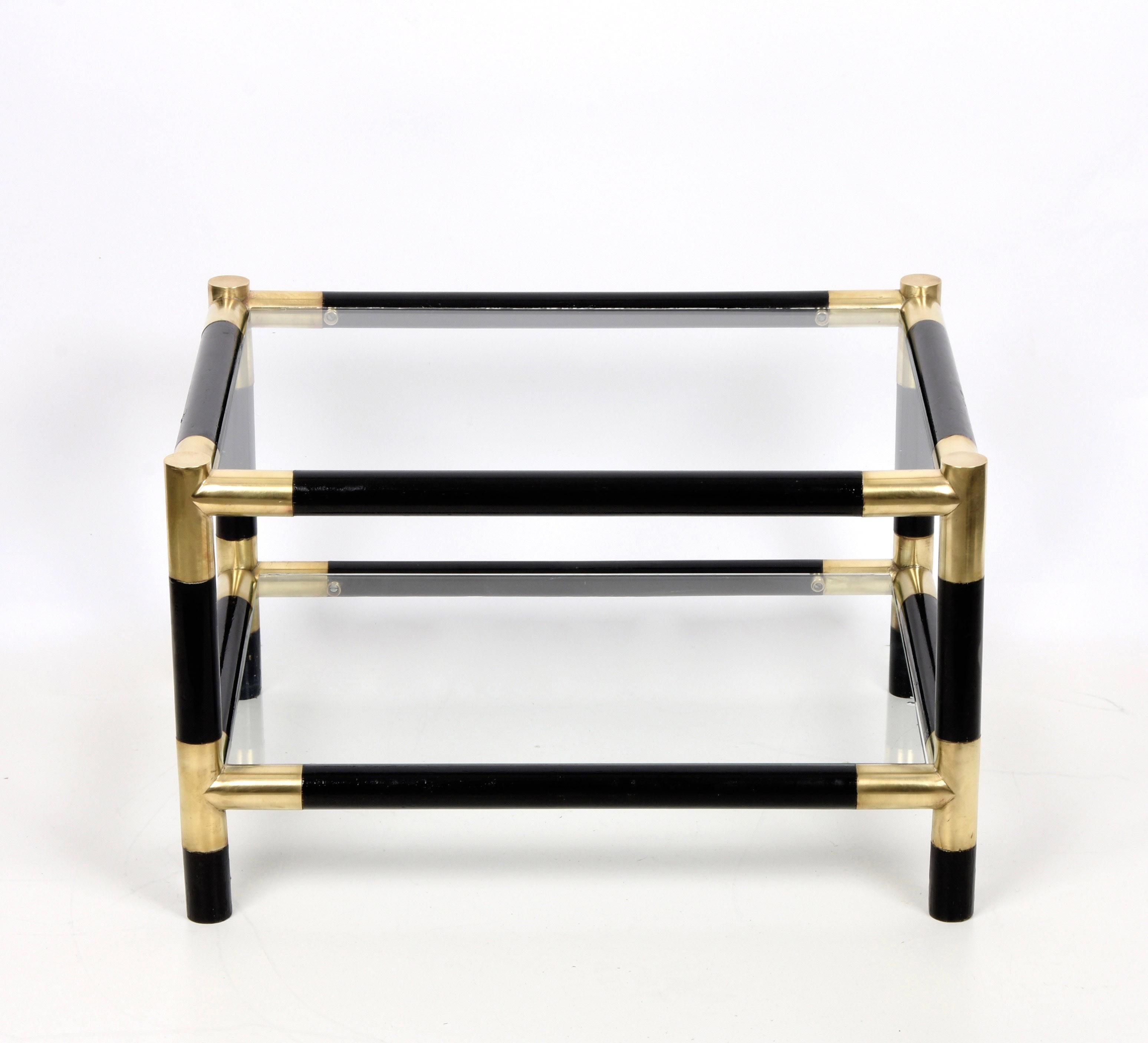 Amazing midcentury side table in lacquered black wood with half-century brass and two crystal shelves. This fantastic side table was produced in Italy during the 1970s. 

This side table conveys elegant and delicate feelings. This piece is solid,